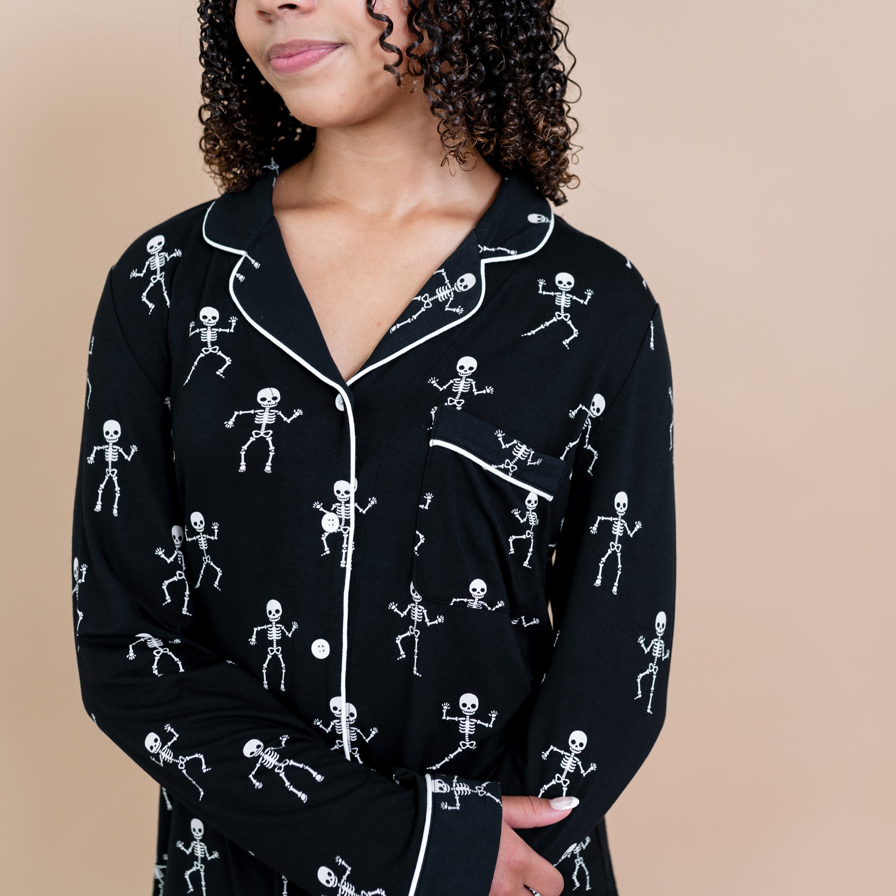 Close up of the Long-Sleeved Women's Pajama Set in Skeleton cloud trim detail and chest pocket on a model