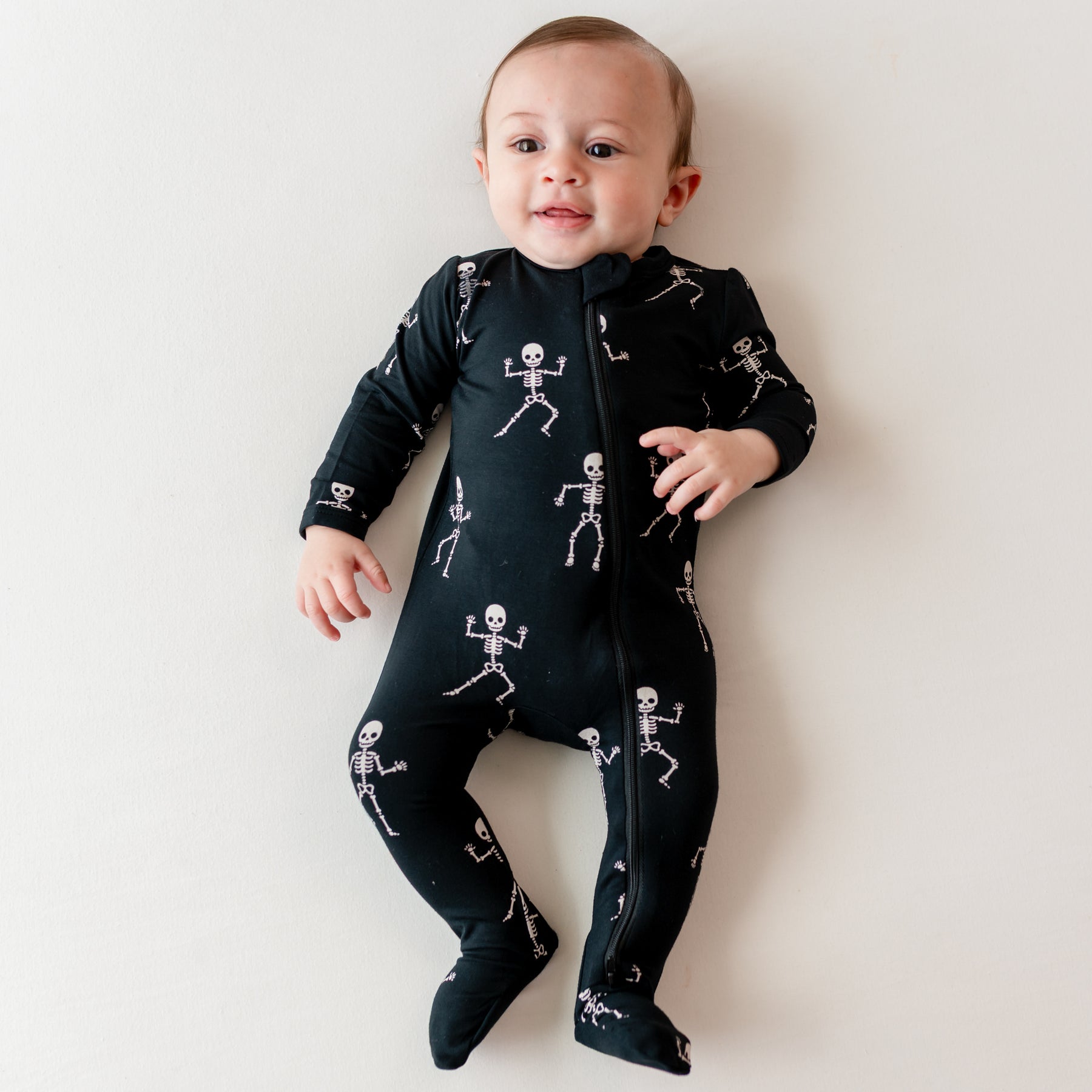 Infant wearing Zippered Footie in Skeleton