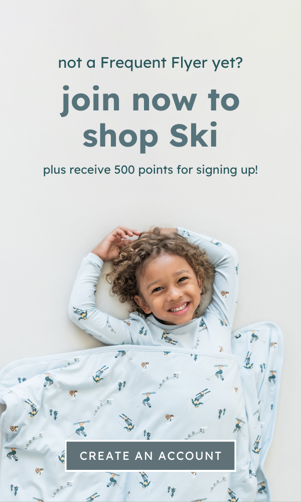 Child in a patterned outfit with promotional text for joining Kyte Baby's frequent flyer program. 