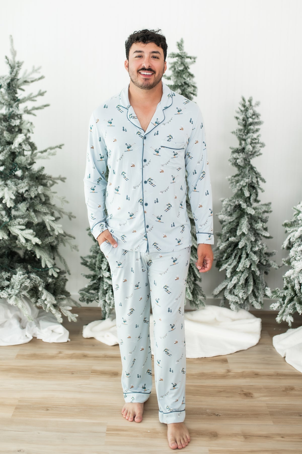 Smiling male model walking wearing the Men's Long Sleeve Pajama Set in Ski with one hand in the pants pocket
