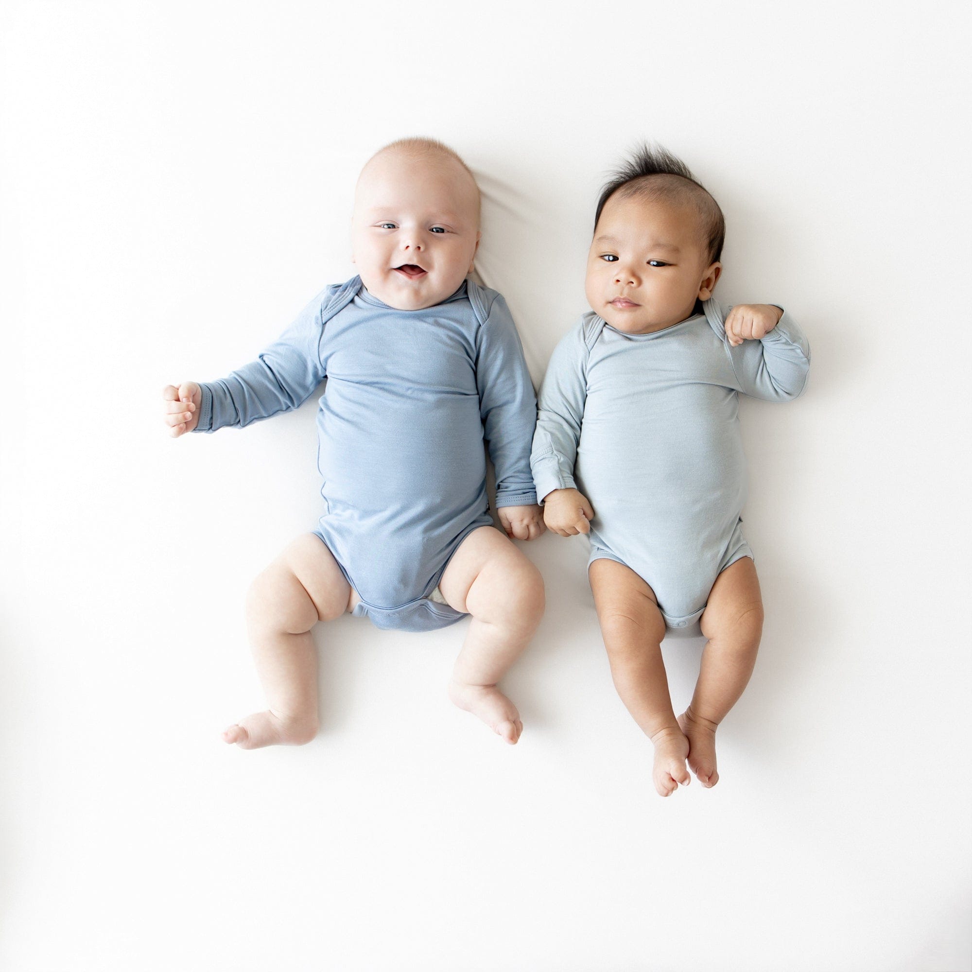 2 babies wearing Fog and Slate long sleeve bodysuits