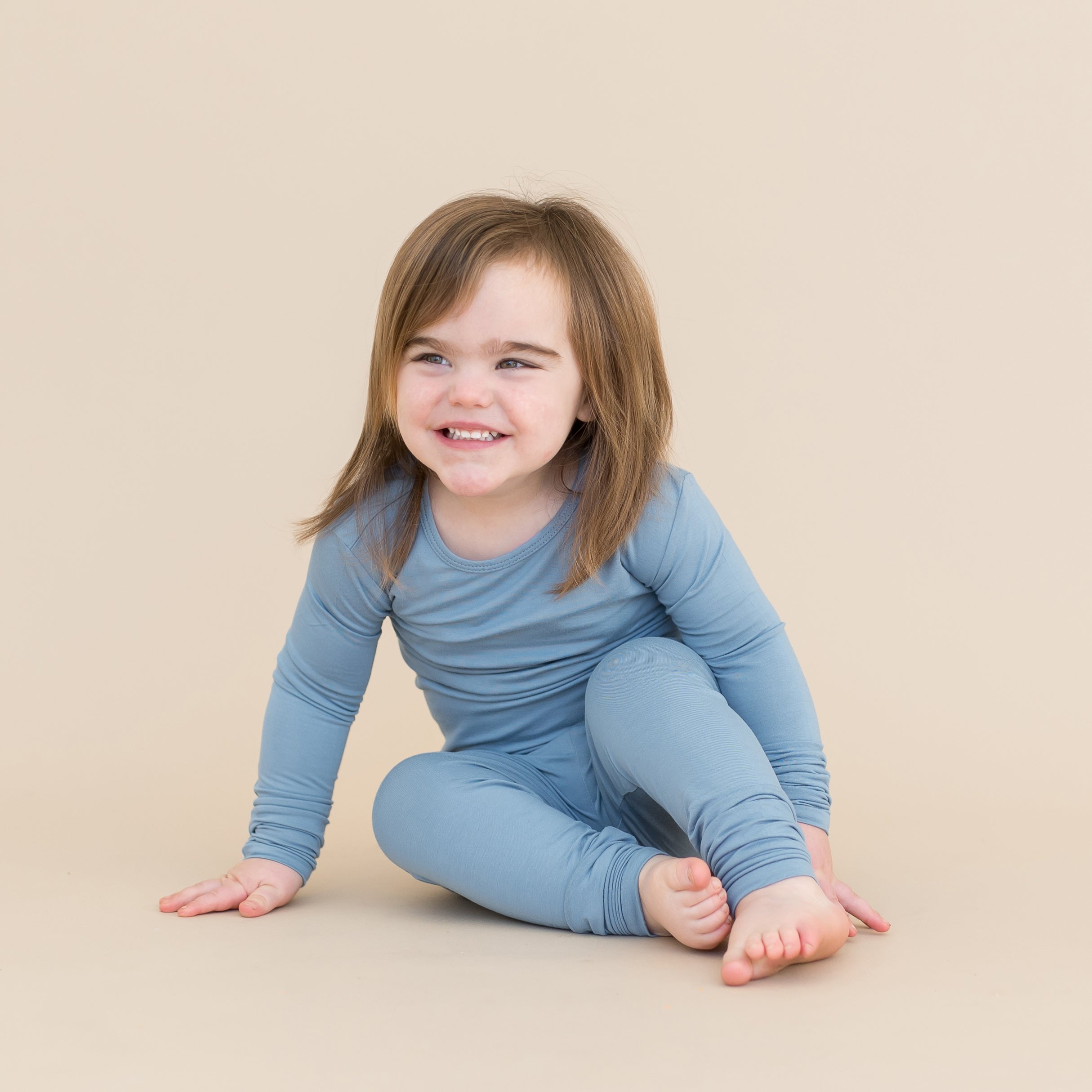 Toddler wearing slate blue long sleeve pajamas