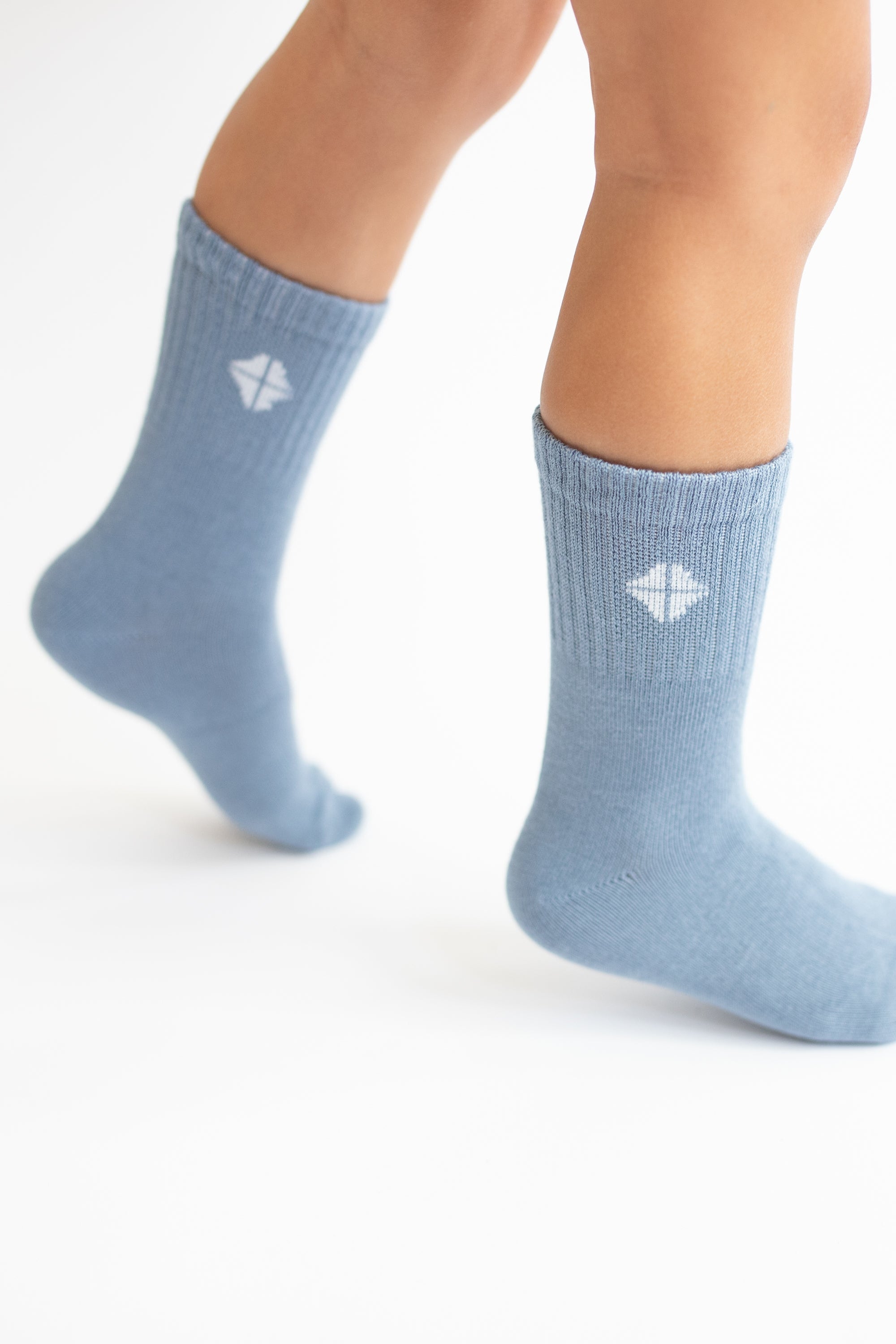 Crew Socks in Slate shown on a toddler model with the Kyte Logo visible