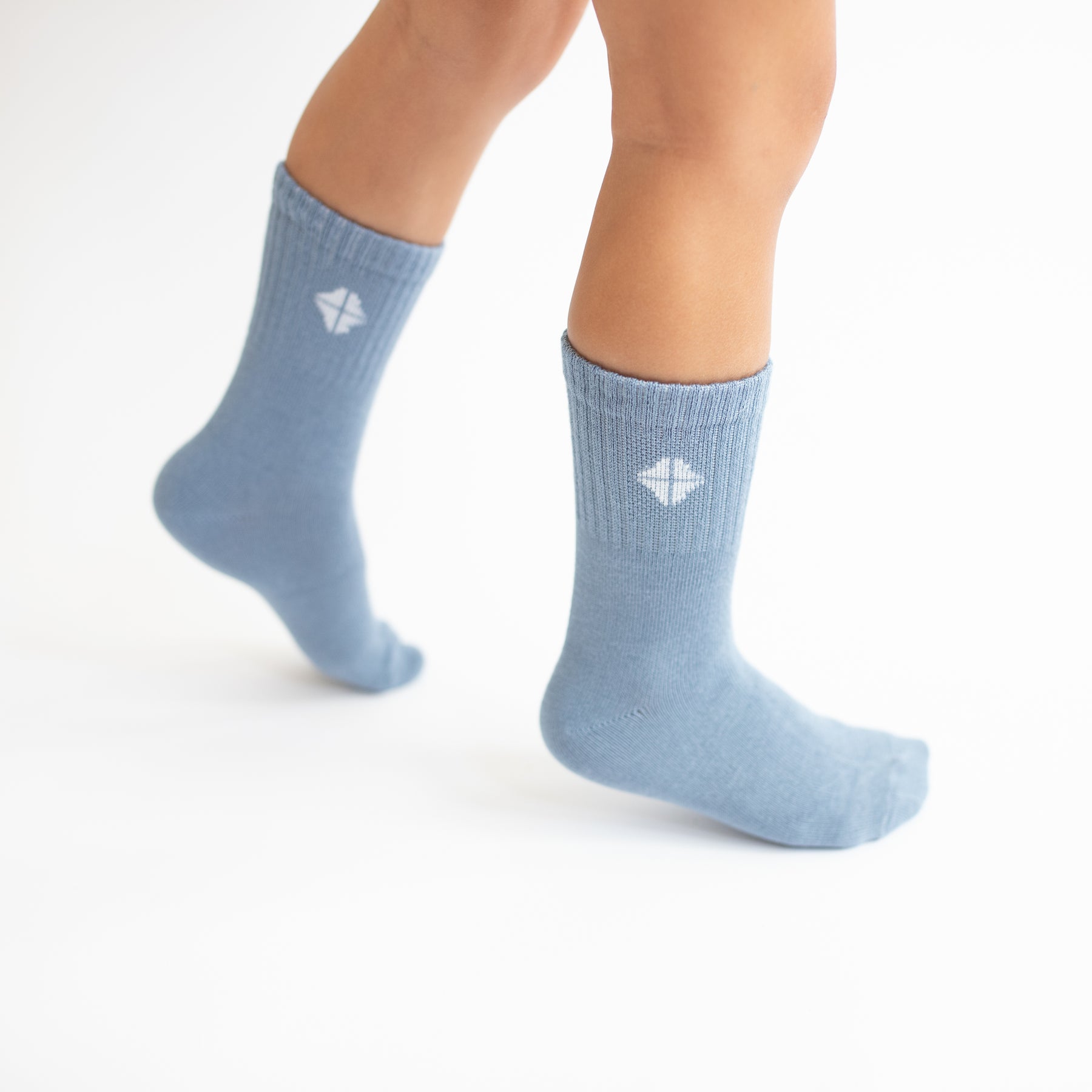 Crew Socks in Slate shown on a toddler model with the Kyte Logo visible
