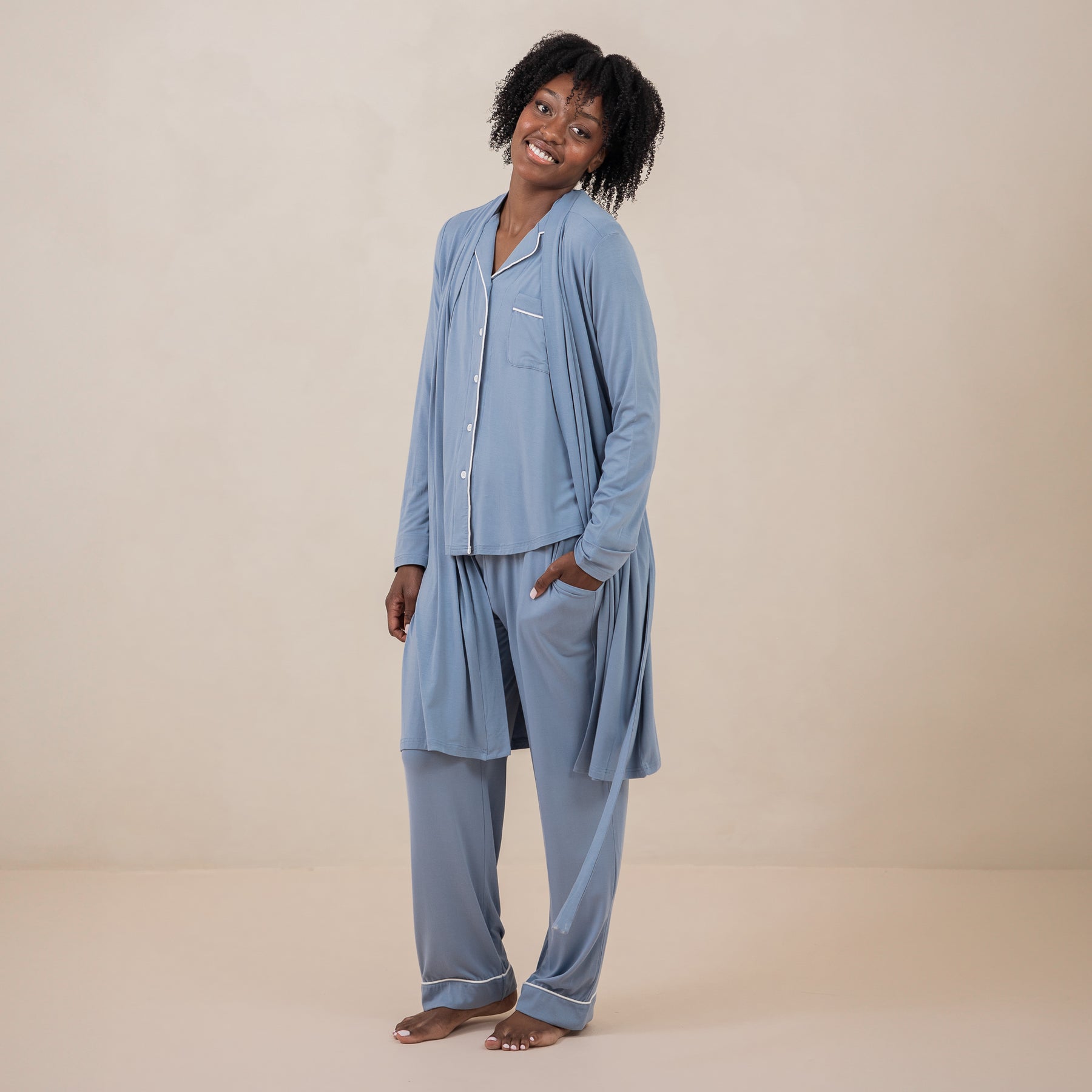 Smiling female model wearing the Women's Lounge Robe in Slate untied with matching long sleeve women's pajama set on underneath