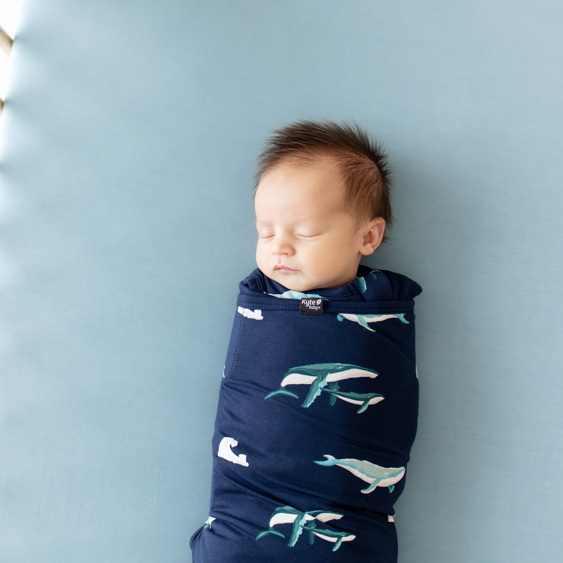 Close up of Baby sleeping in Kyte Sleep Bag Swaddler in Humpback