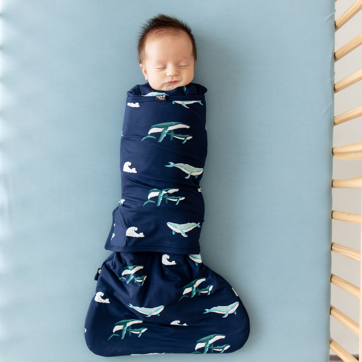 Baby sleeping in Kyte Sleep Bag Swaddler in Humpback