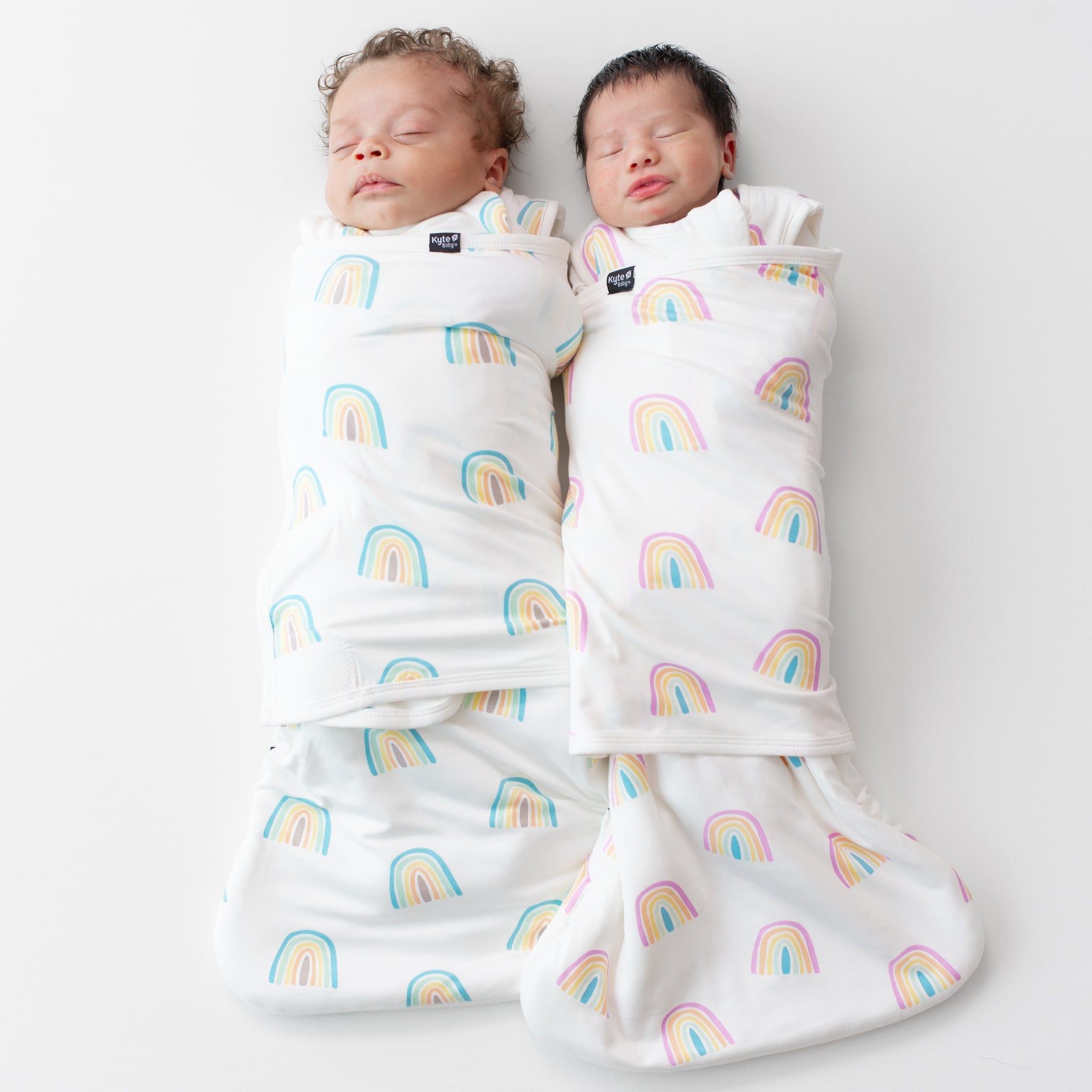 Two babies sleeping in sleep bag swaddlers 1.0 in poi and makai rainbow