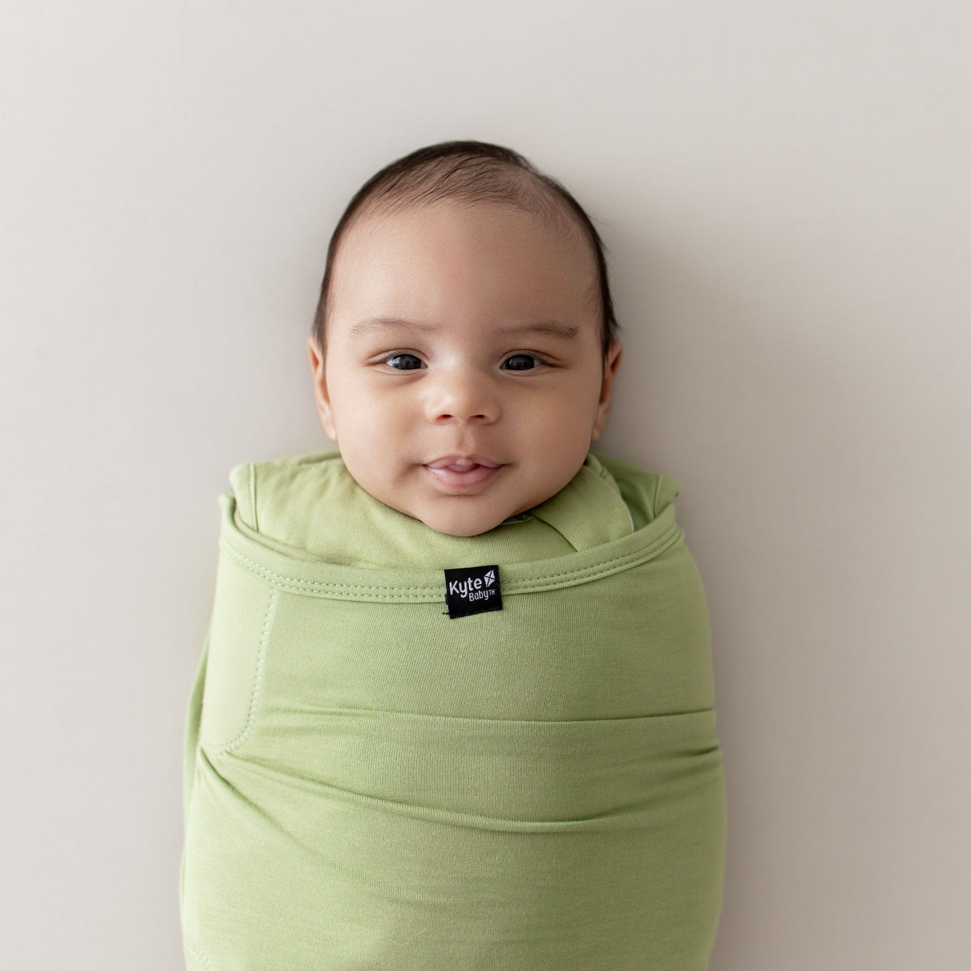 sleep bag swaddler in honu  on baby