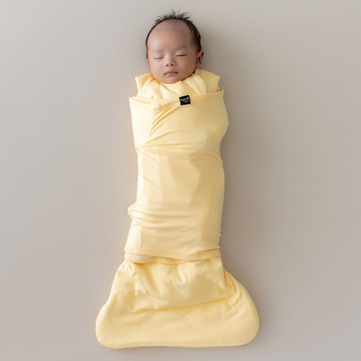 kyte baby lilikoi sleep bag swaddler on sleeping baby