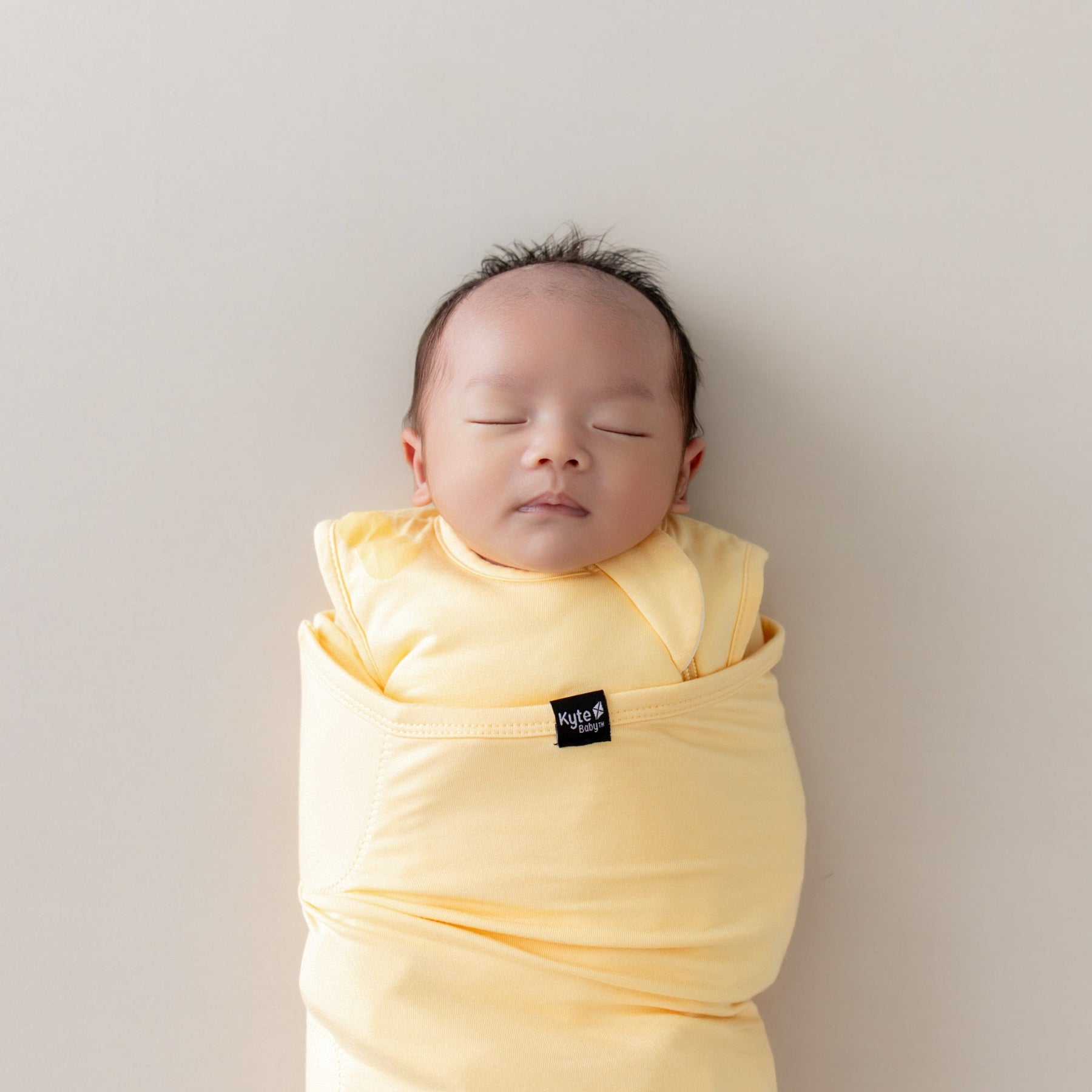 baby sleeping in lilikoi sleep bag swaddler by kyte baby