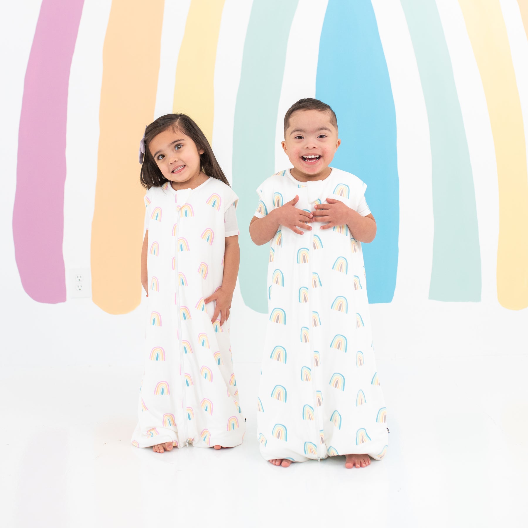 Two toddlers modeling Sleep Bag Walkers in Makai and Poi Rainbow