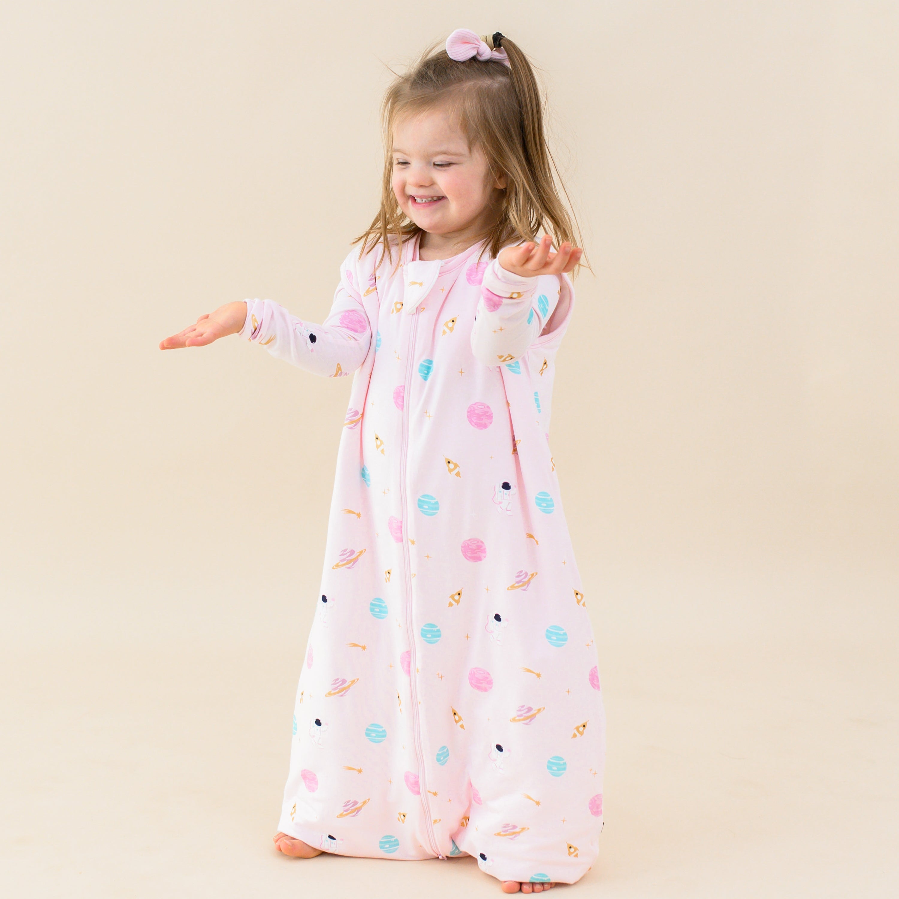 toddler smiling wearing sakura space sleep bag walker and pajamas