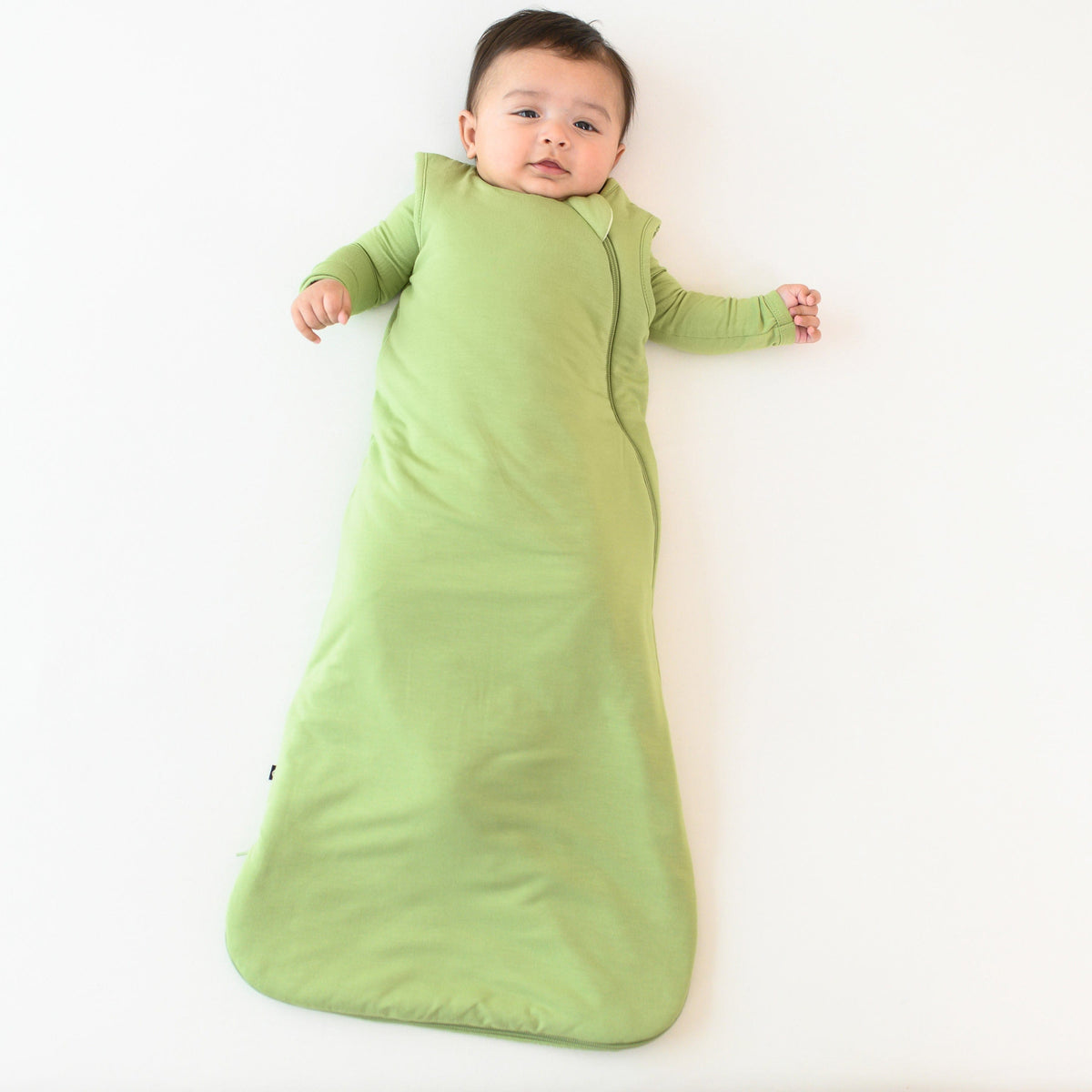 baby wearing kyte baby 1.0 sleep bag in honu