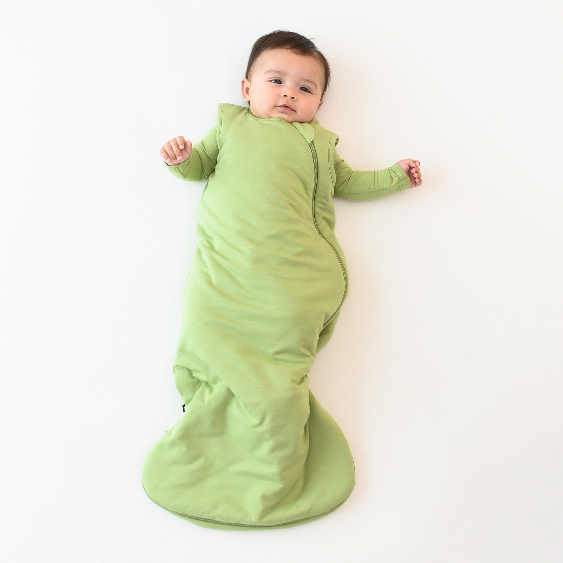 baby wearing kyte baby 1.0 sleep bag in honu