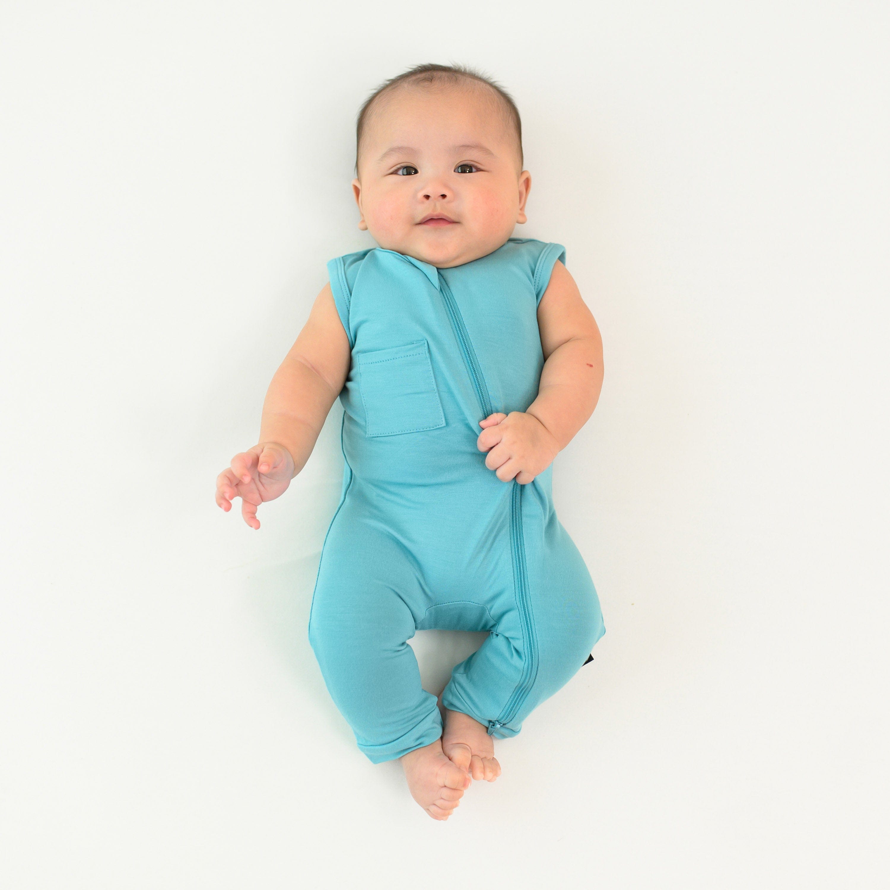 baby wearing zippered sleeveless romper in makai 