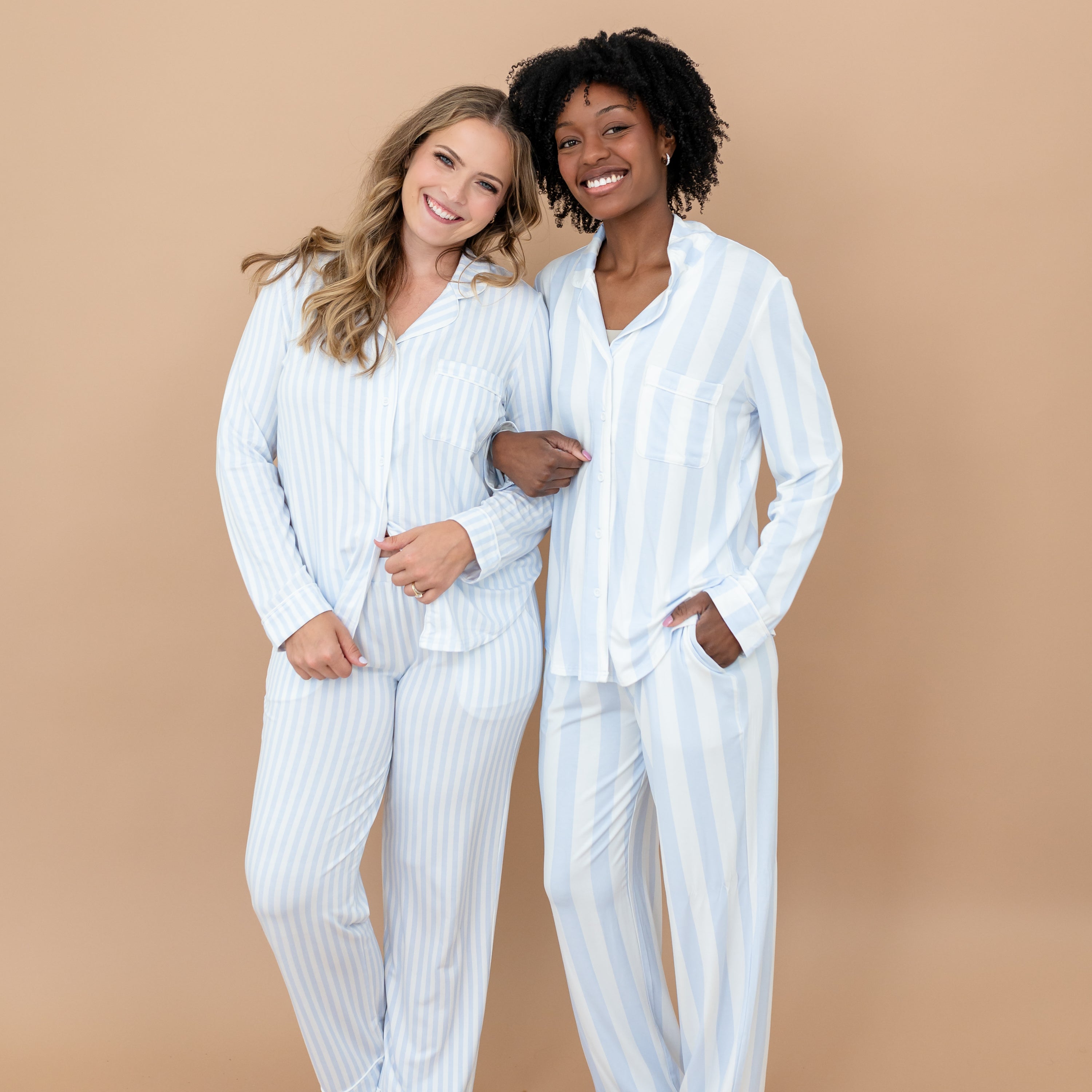 Two female models standing side by side with their arms linked wearing the Long-Sleeved Women's Pajama Set in Big Mist Stripe and Small Mist Stripe