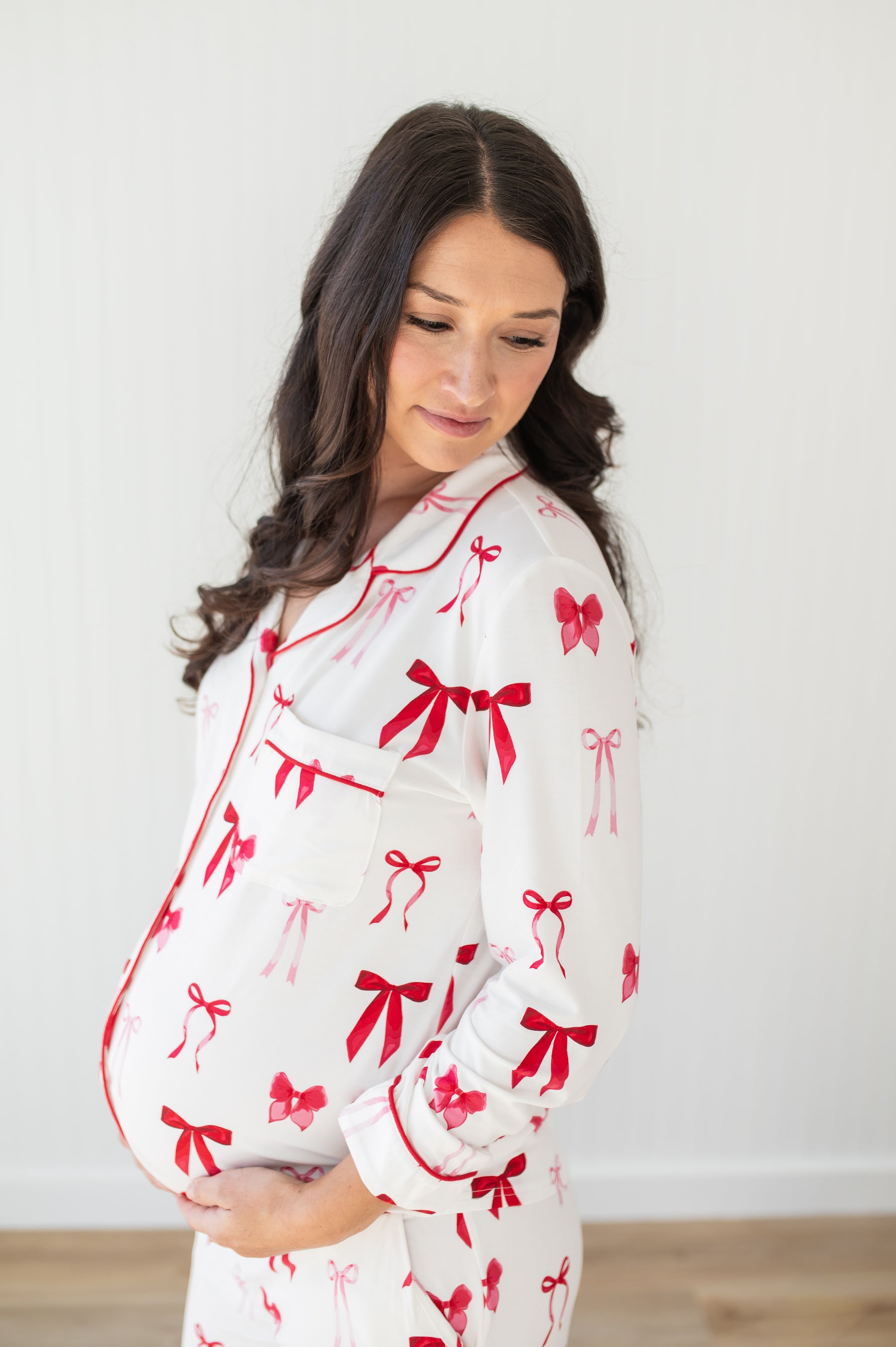 Close up of expectant mother wearing the Long-Sleeved Women's Pajama Set in Big Love Bow