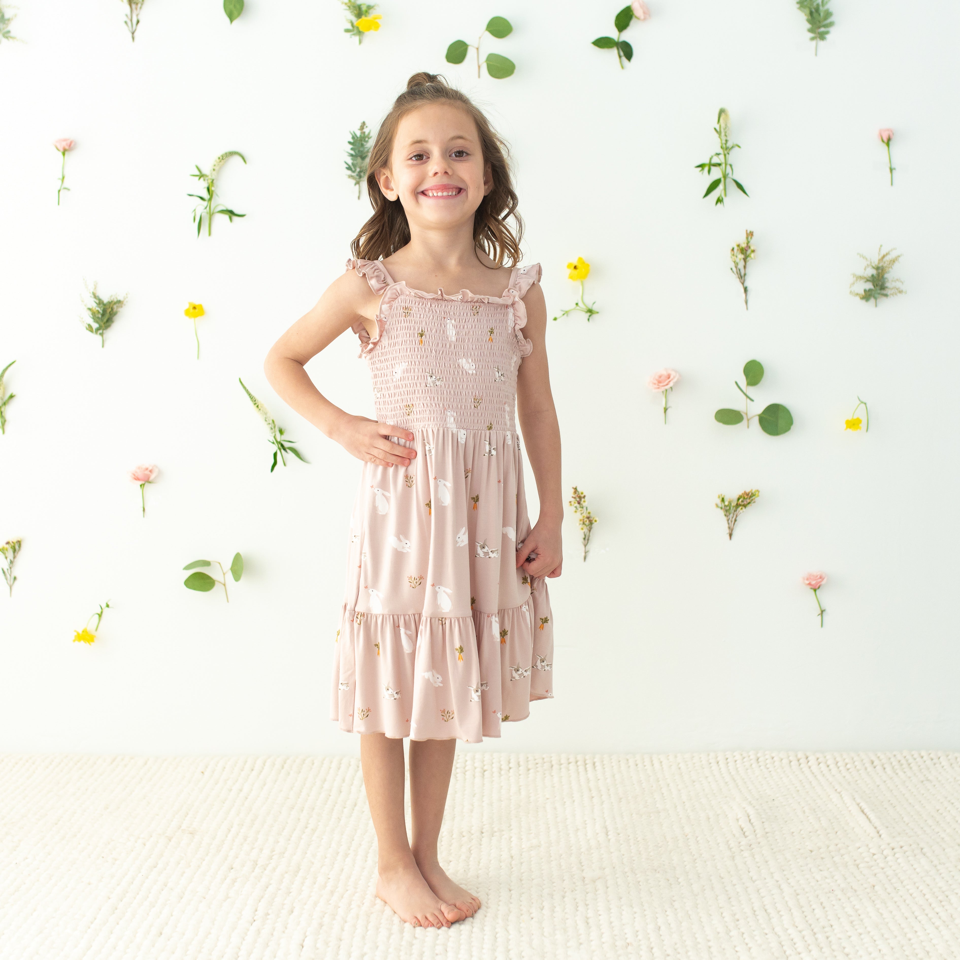 Child wearing Smocked Dress in Blush Rabbit