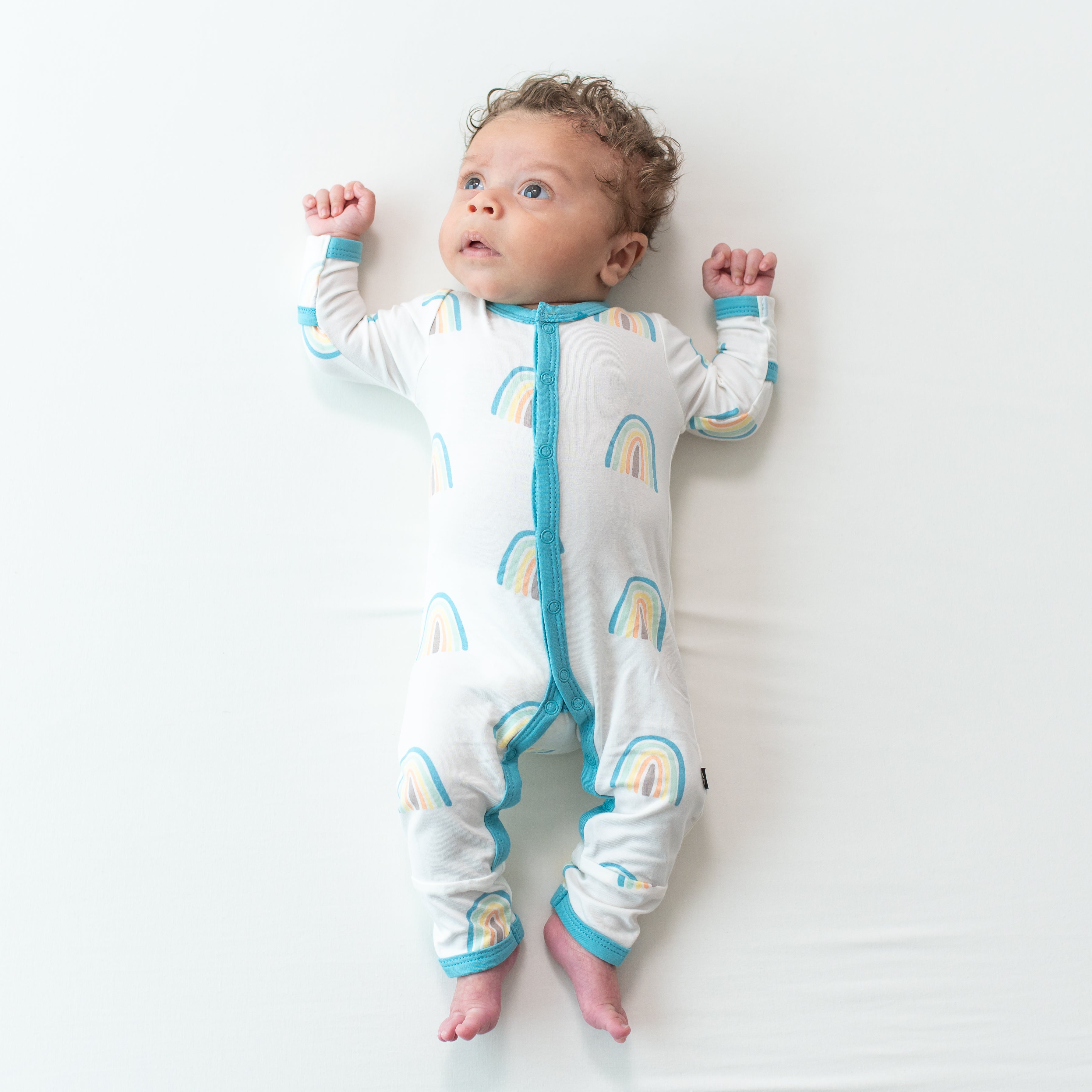 Baby wearing Romper in Makai Rainbow