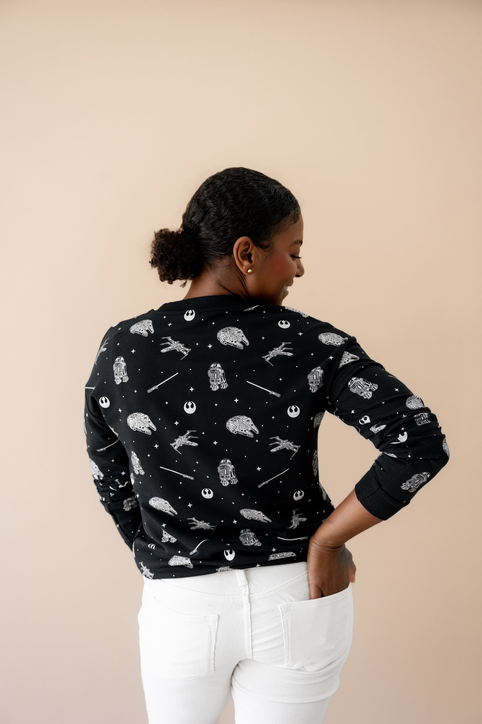 The back of the Women's Sweatshirt in STAR WARS™ shown on a model paired with white jeans