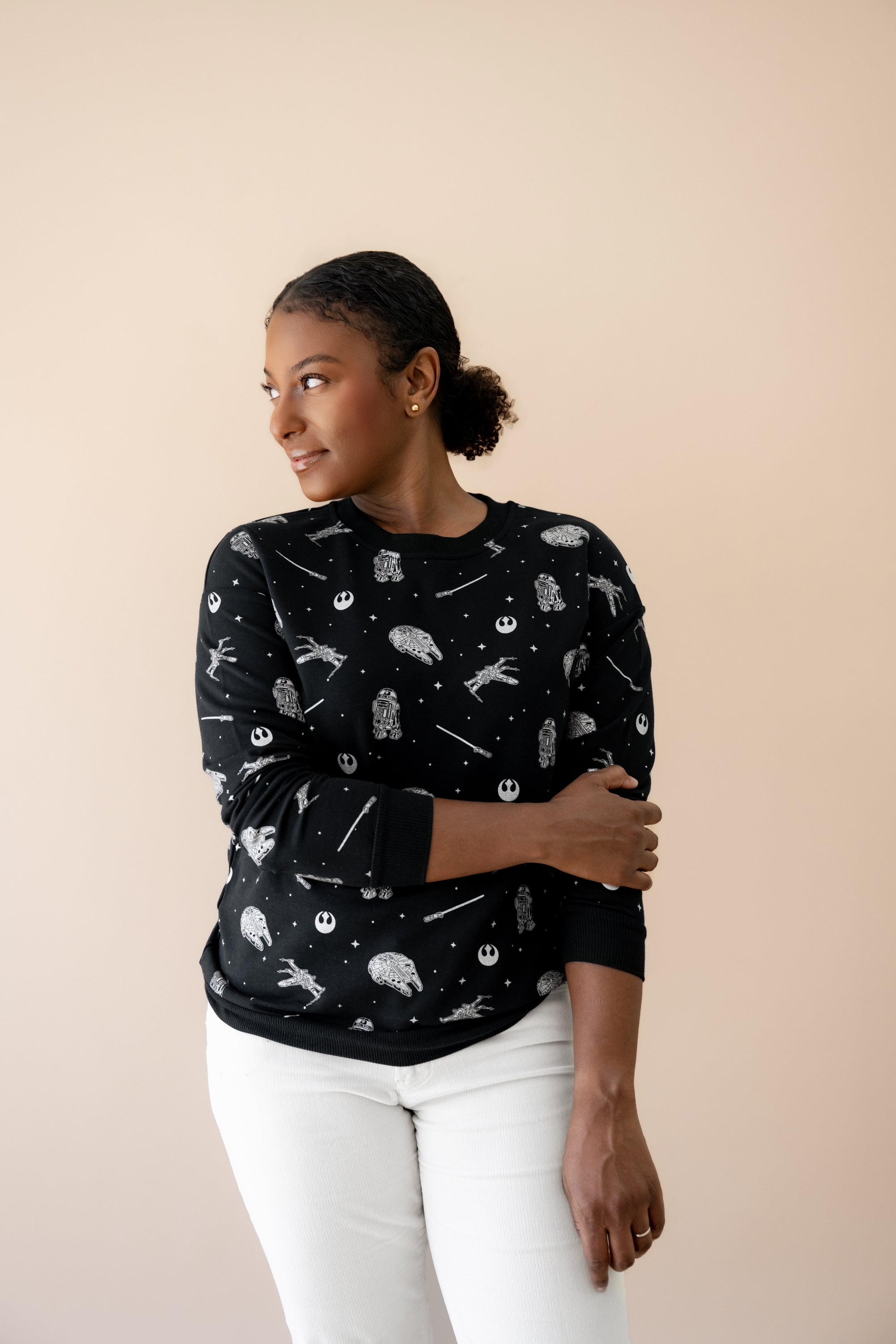 Female modeling the Women's Sweatshirt in STAR WARS™ paired with white jeans