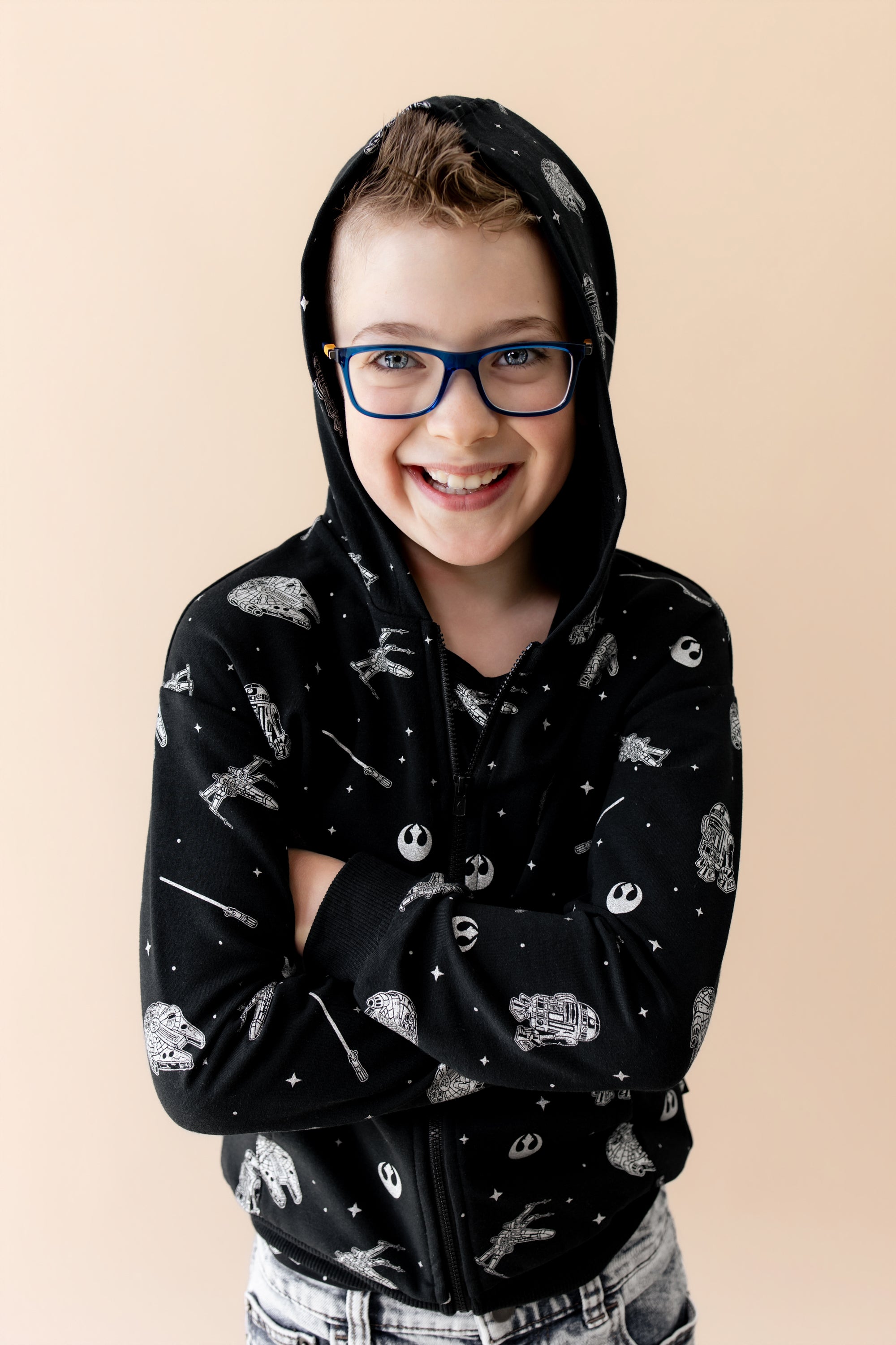 Young boy modeling the Zip-Up Hoodie in STAR WARS™ with the hood up