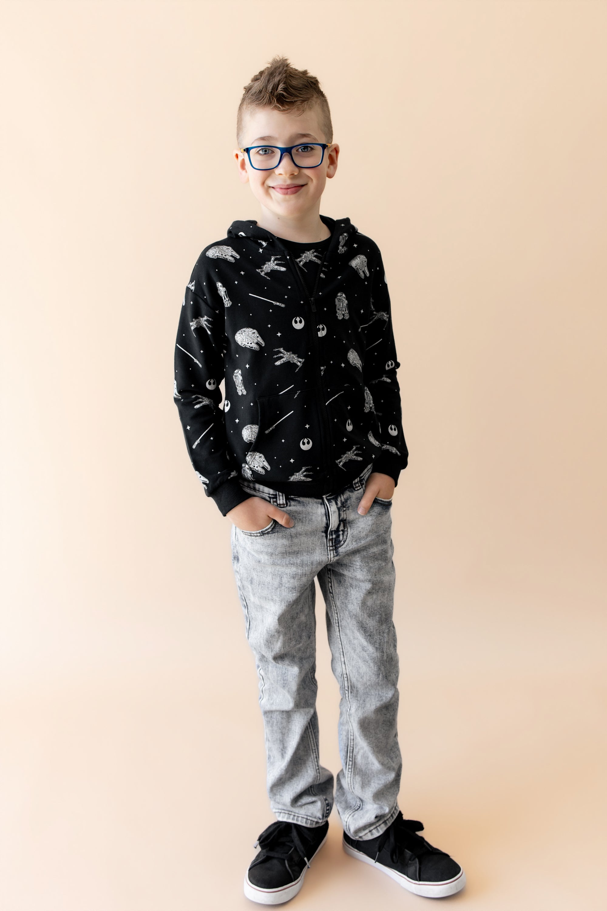 Young boy modeling the Zip-Up Hoodie in STAR WARS™ paired with light denim jeans