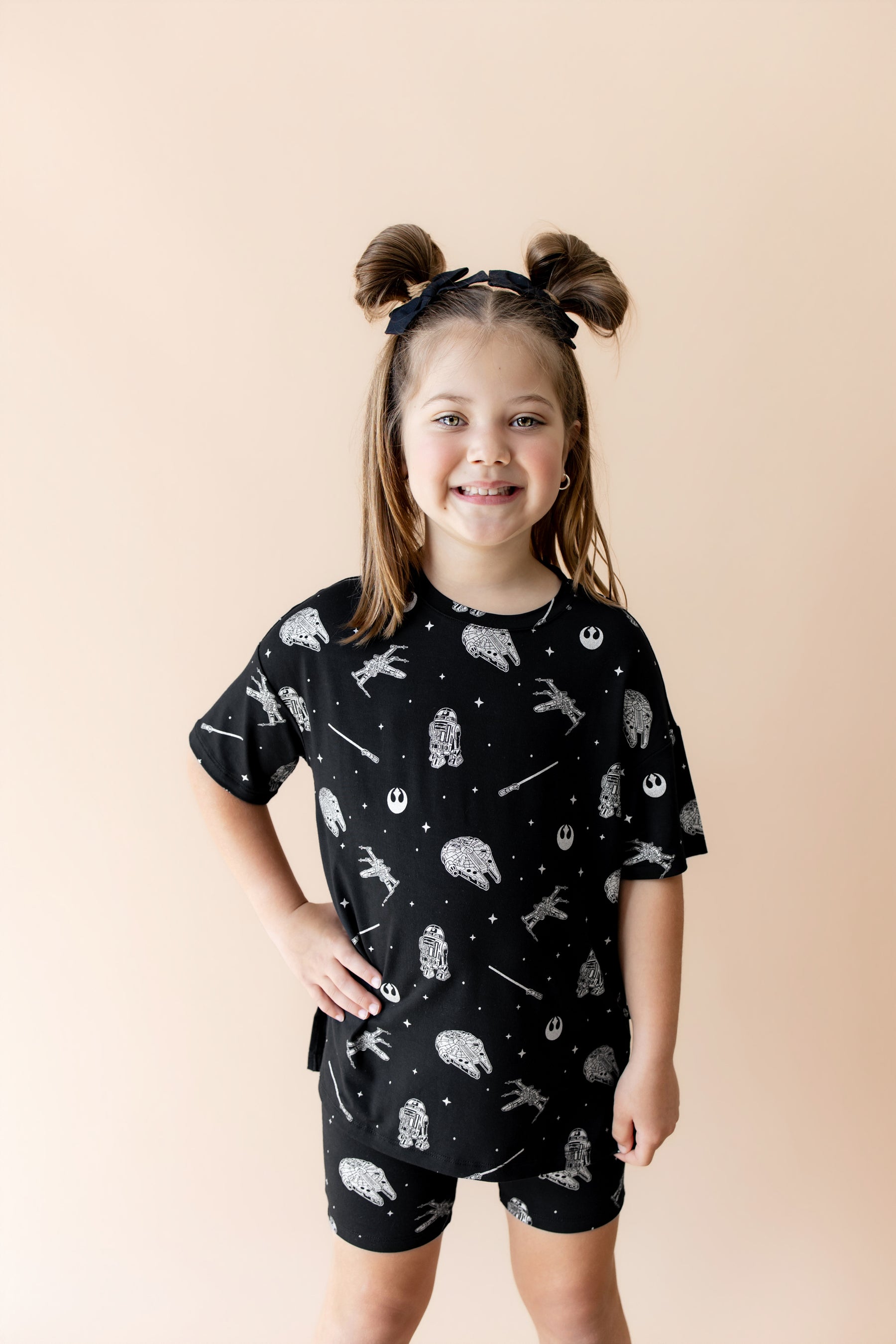 Young girl modeling the Toddler Biker Short Set in STAR WARS™ with one hand on her hip