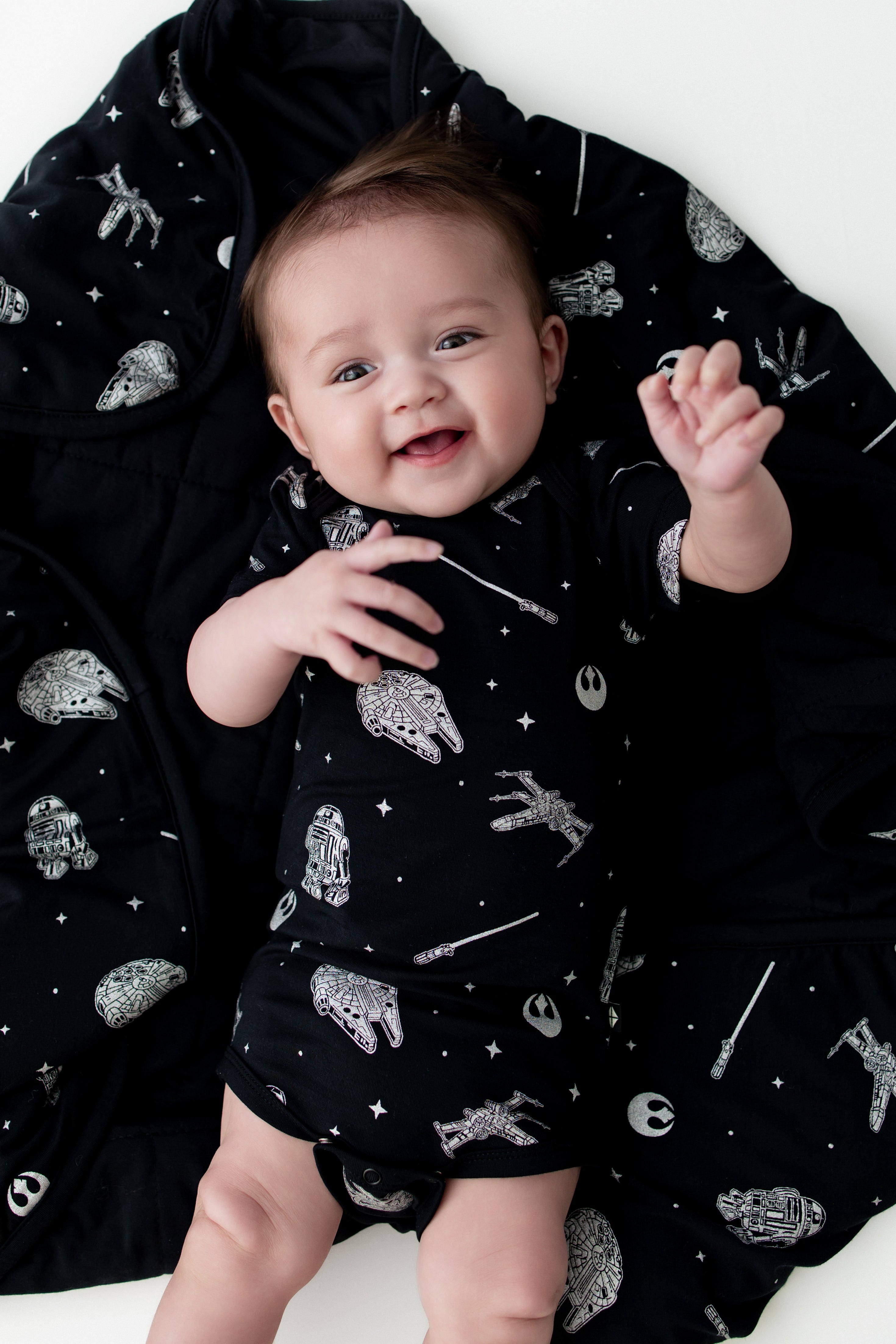 Close up of infant laying on a Baby Blanket in STAR WARS™ wearing a matching short sleeve bodysuit