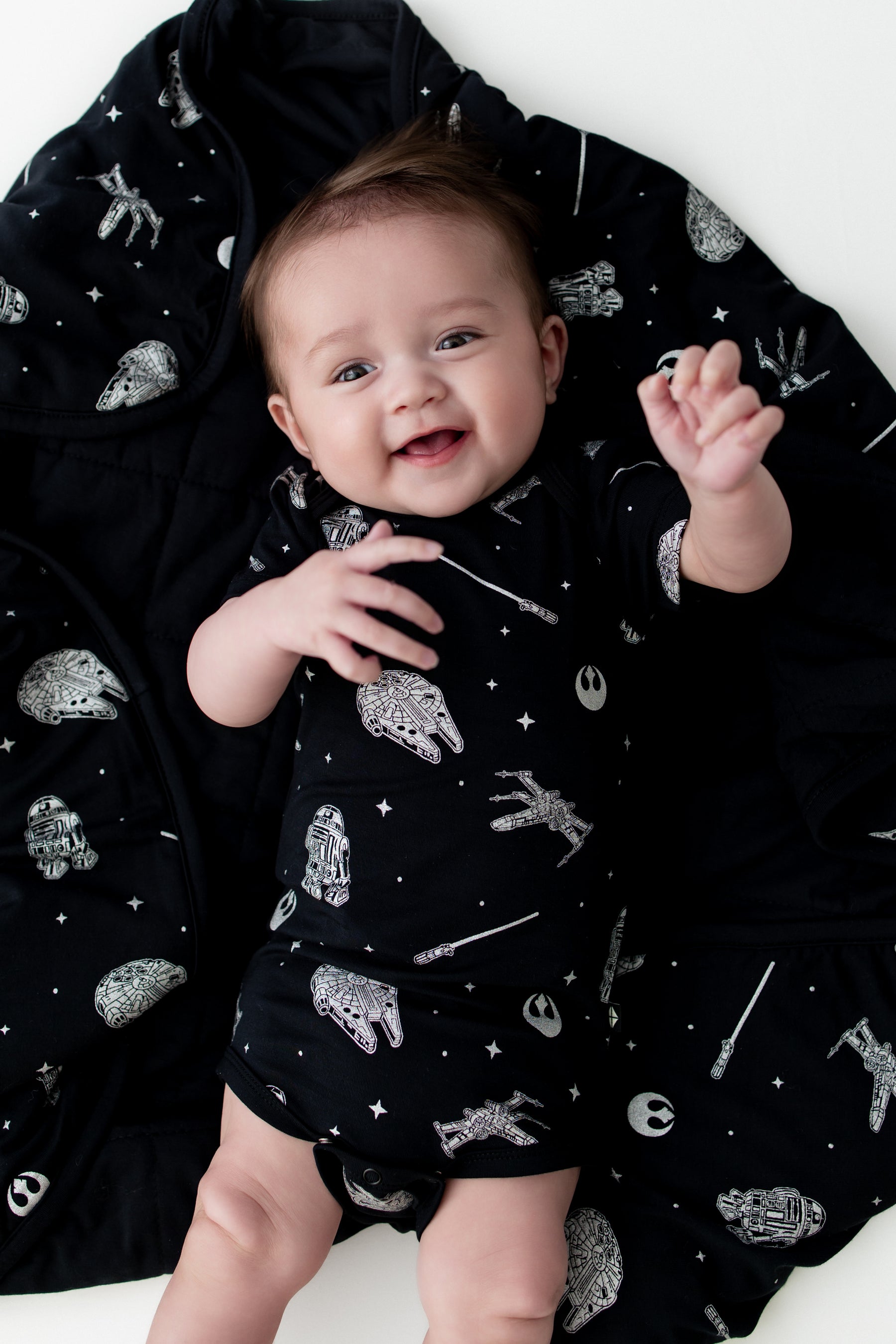 Close up of infant laying on a Baby Blanket in STAR WARS™ wearing a matching short sleeve bodysuit