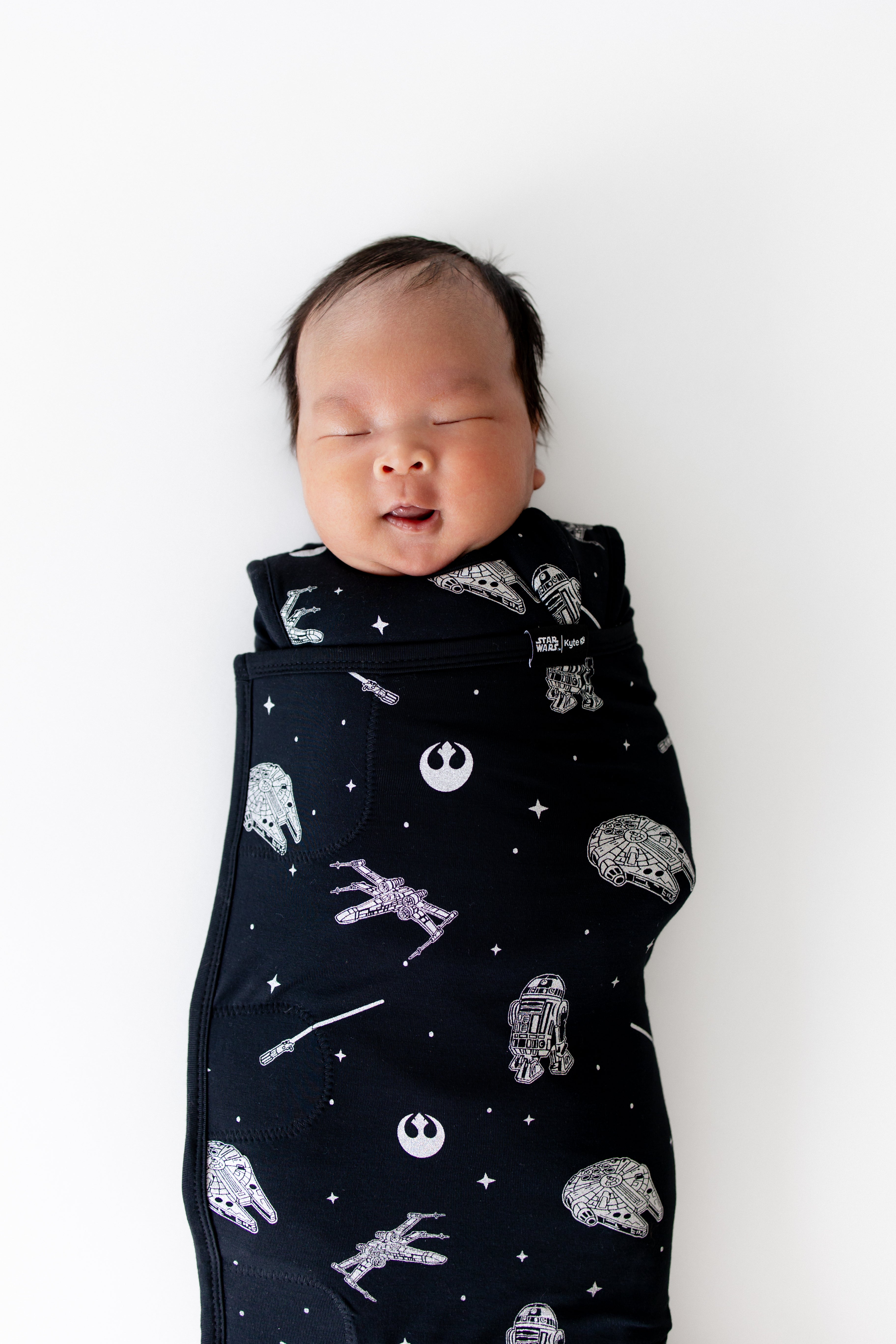Close up of sleeping newborn swaddled in the Sleep Bag Swaddler in STAR WARS™ 1.0