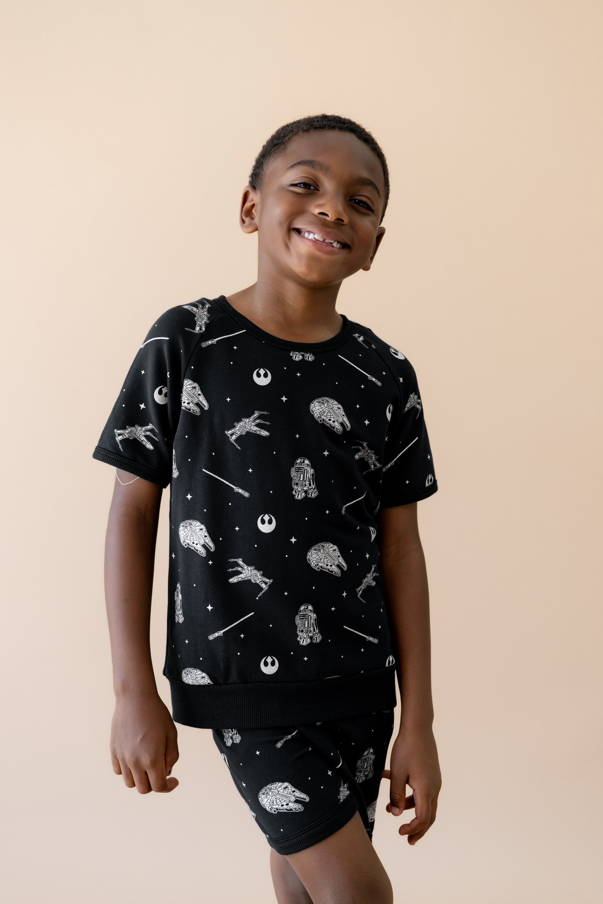 Smiling boy wearing the Short Sleeve Jogger Set in STAR WARS™