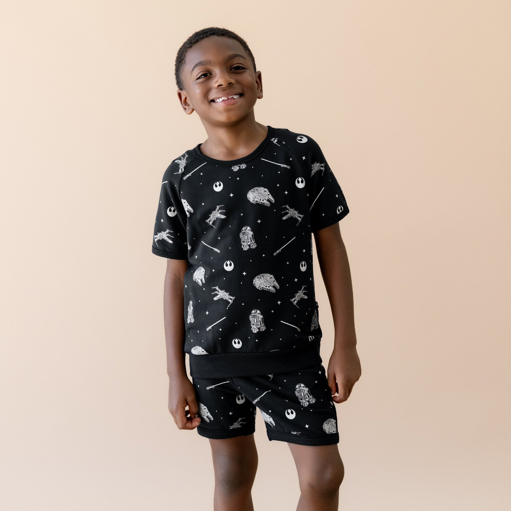 Child wearing a matching short sleeve set with STAR WARS print 