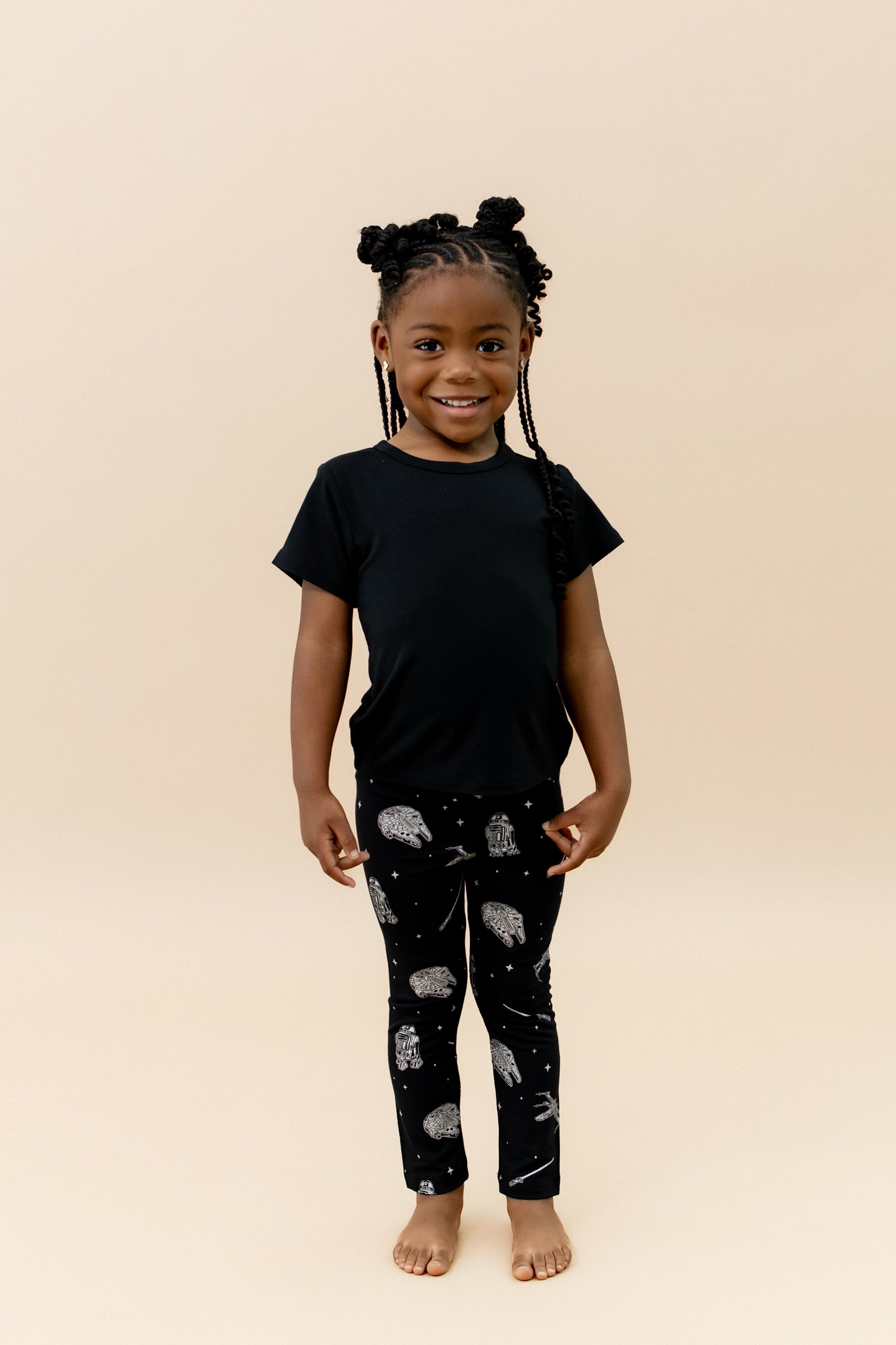 Young girl wearing the Toddler Leggings in STAR WARS™ paired with a midnight basic tee