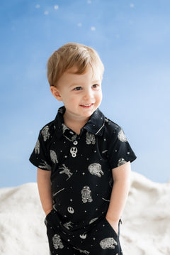 Young boy wearing the Toddler Short Sleeve Polo in STAR WARS™ with matching drawstring shorts