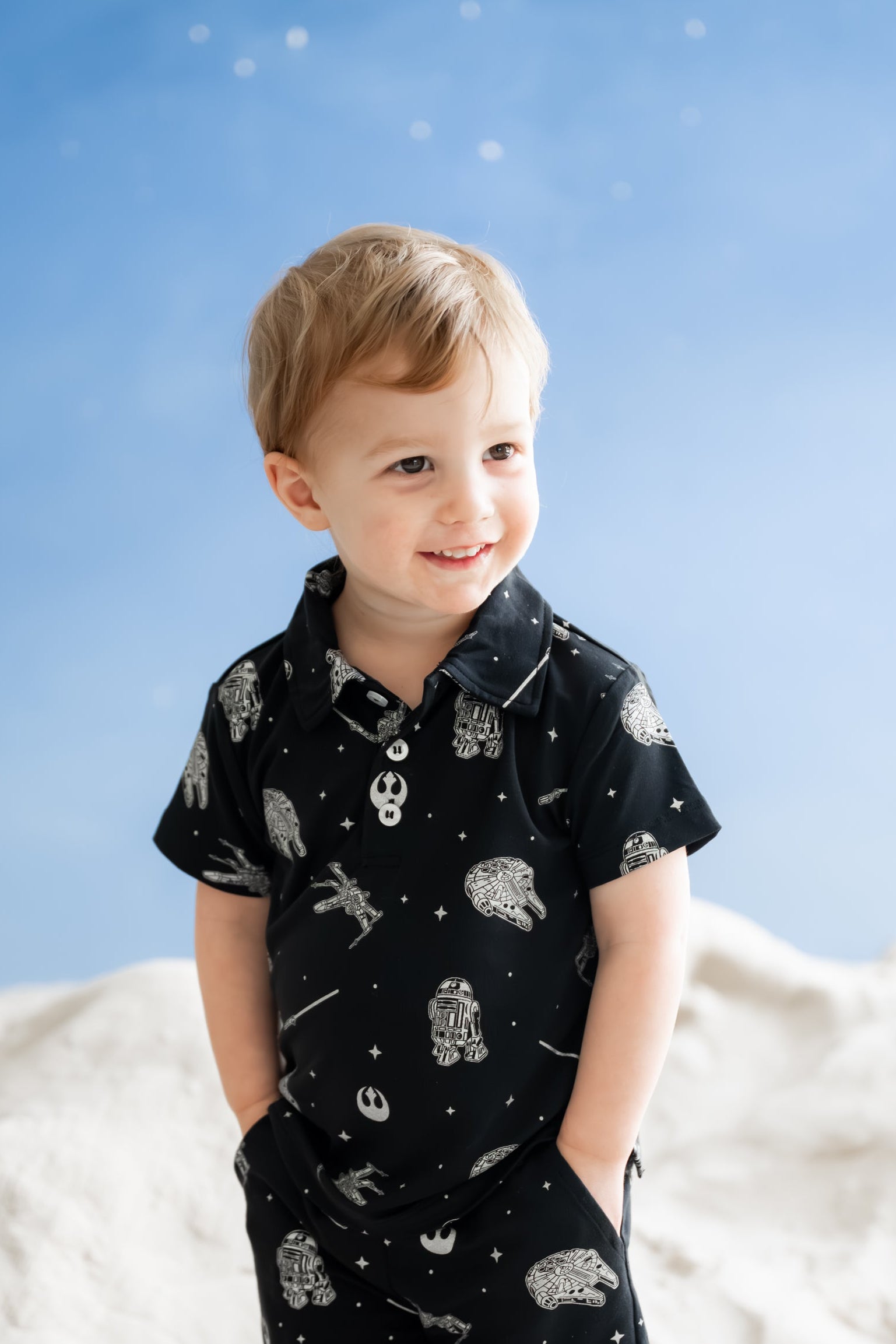 Young boy wearing the Toddler Short Sleeve Polo in STAR WARS™ with matching drawstring shorts