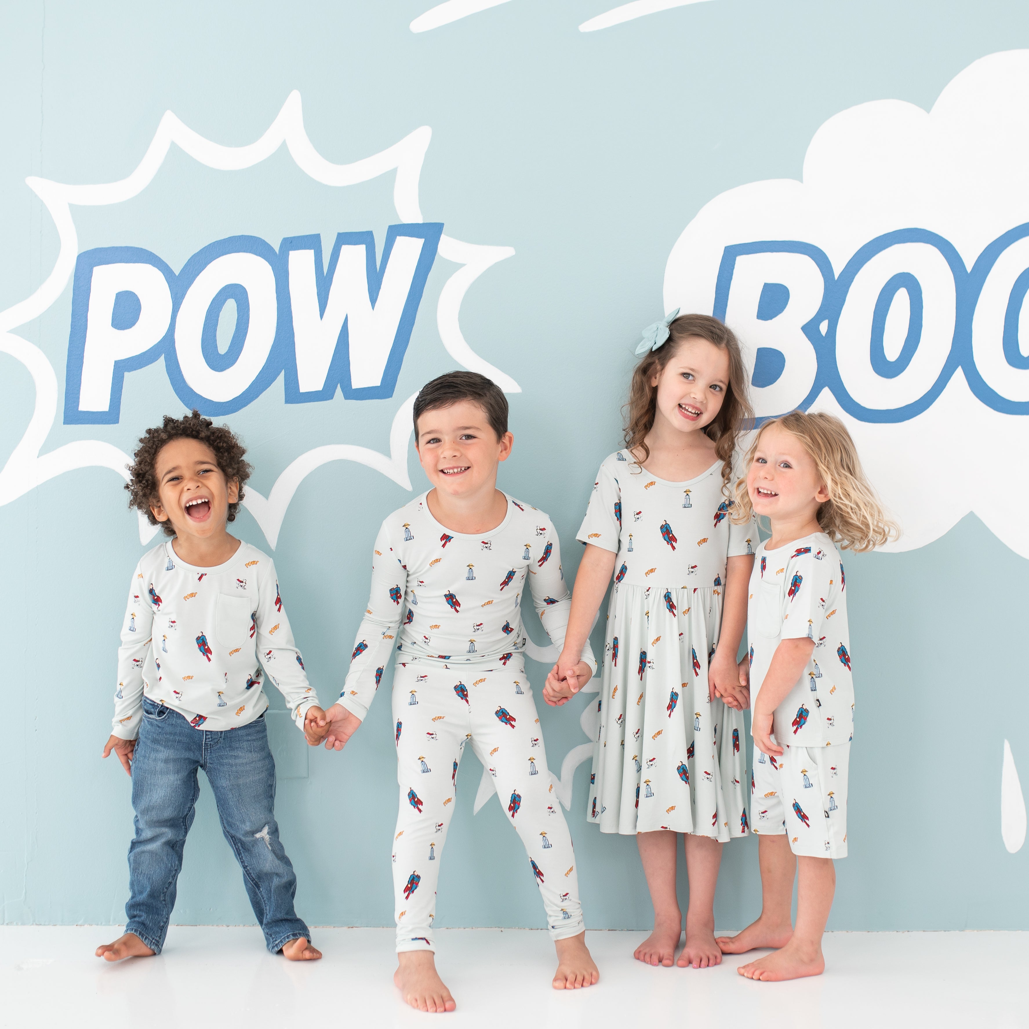 Four children standing holding hands wearing various items from the Superman™ collection