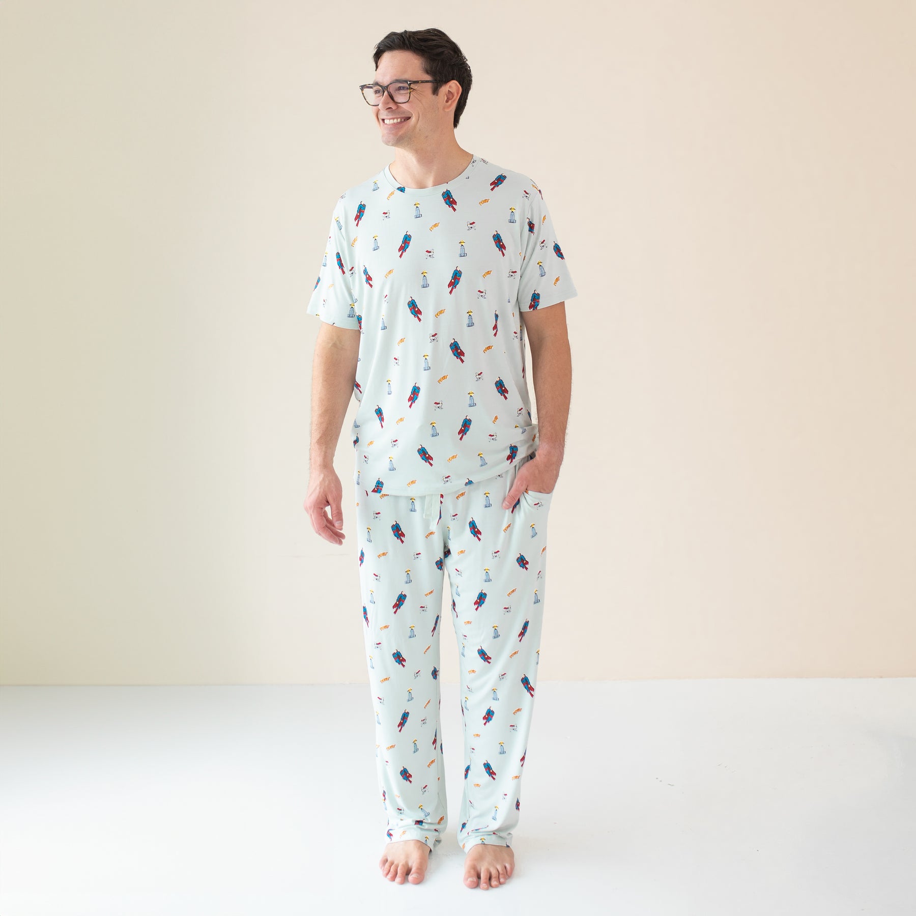 Smiling male model wearing the Men's Lounge Pants in Superman™ with matching Men's Crew Neck Tee