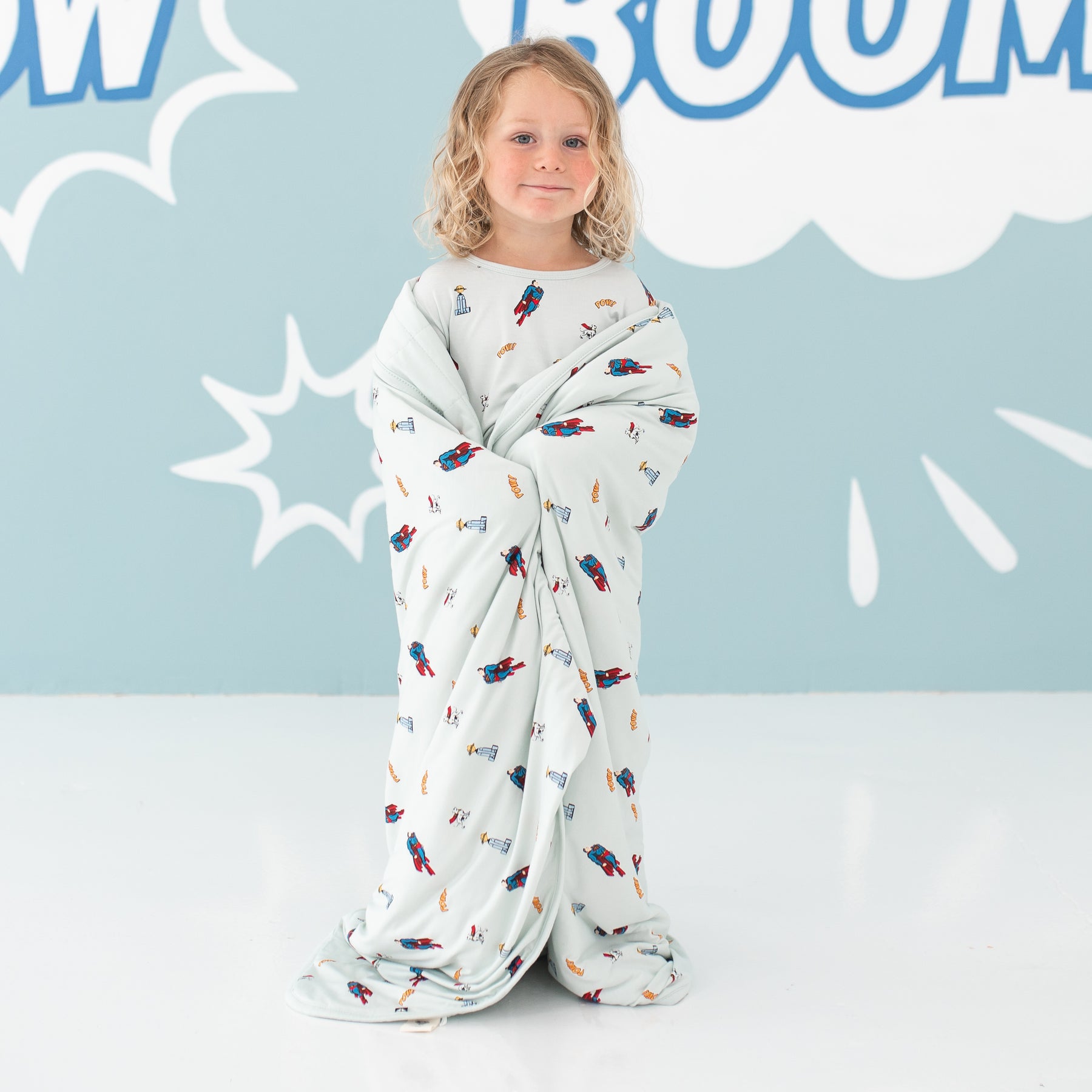 Child wrapped in bamboo Toddler Blanket in Superman™ 1.0 TOG