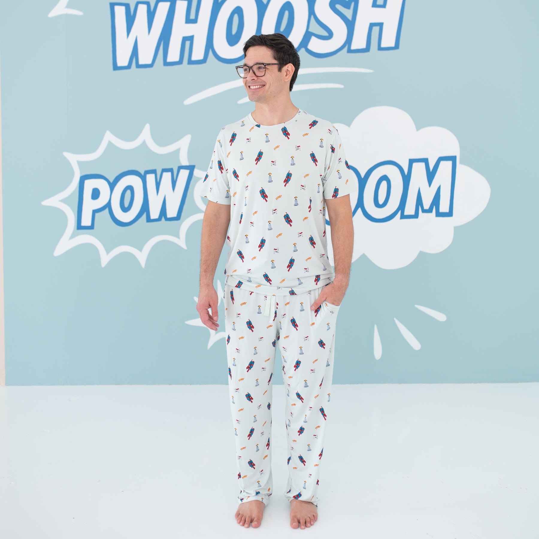 Smiling male model wearing the Men's Lounge Pants in Superman™ paired with a matching Men's Crew Neck Tee