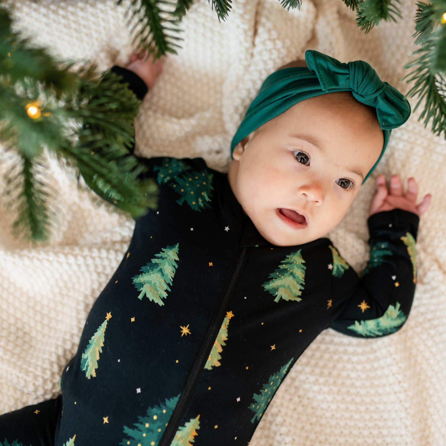 Close up of infant wearing the Zippered Romper in Twinkle Tree