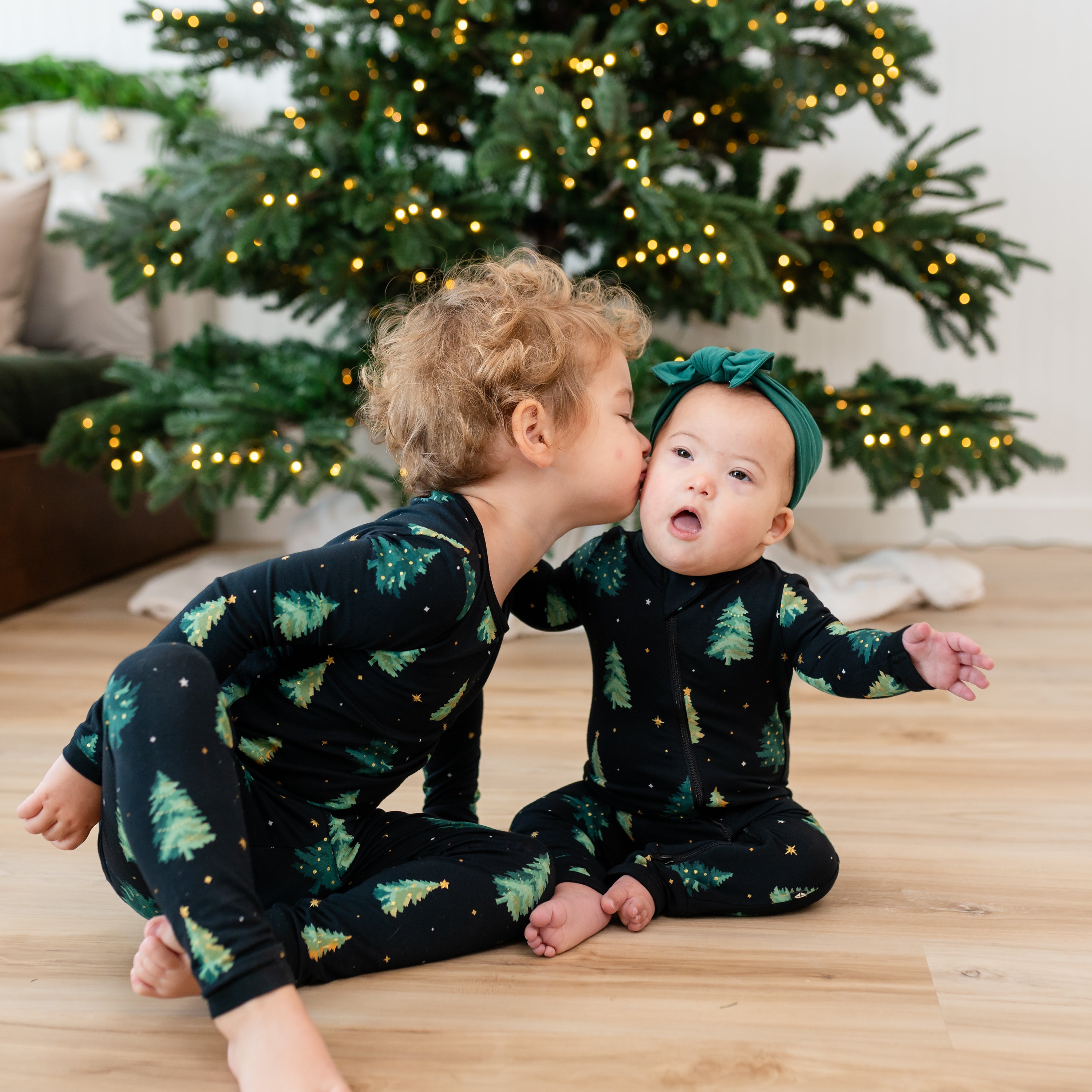 Brother kissing his sisters cheek both matching in Twinkle tree