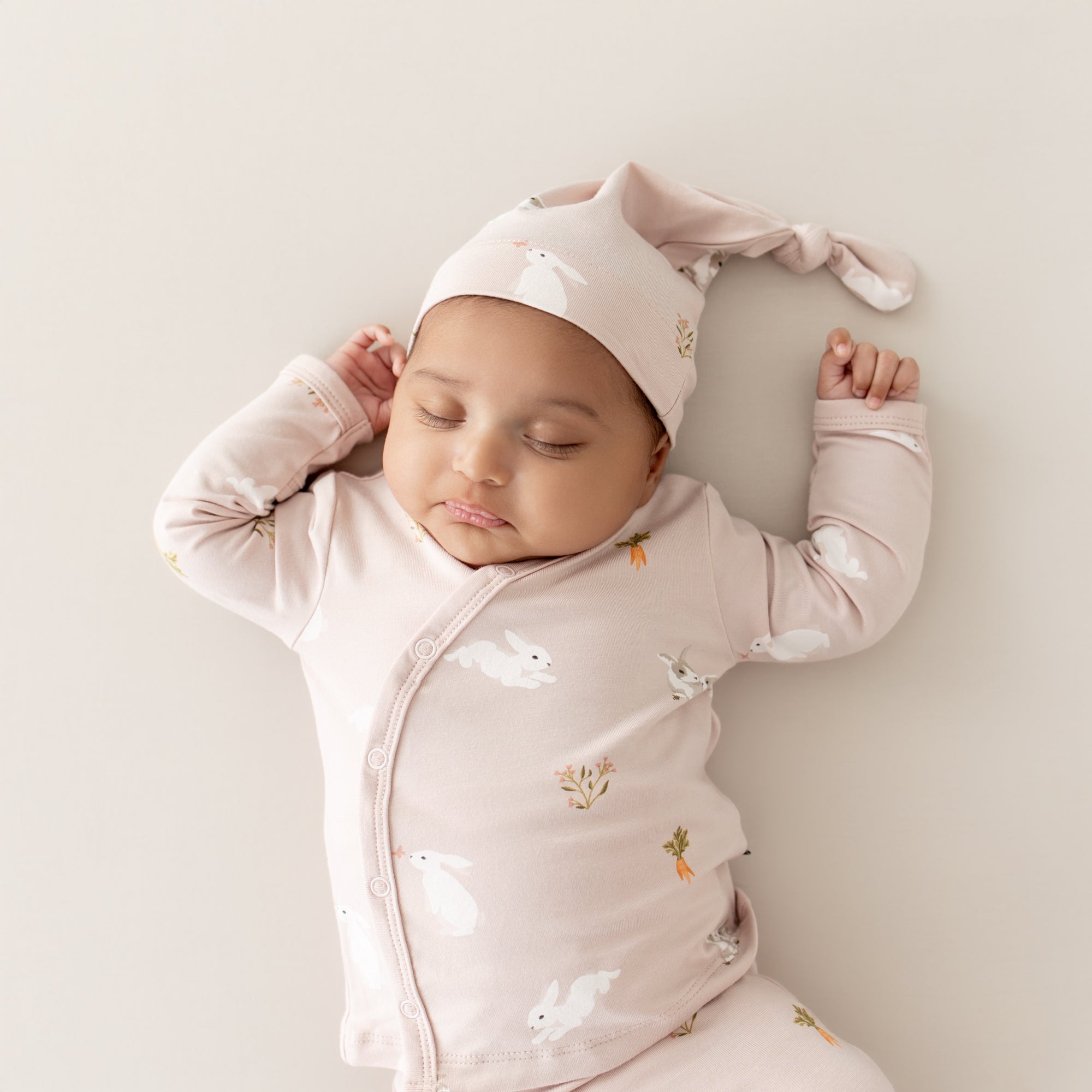 Close up of baby wearing Take Me Home Set with Cap in Blush Rabbit