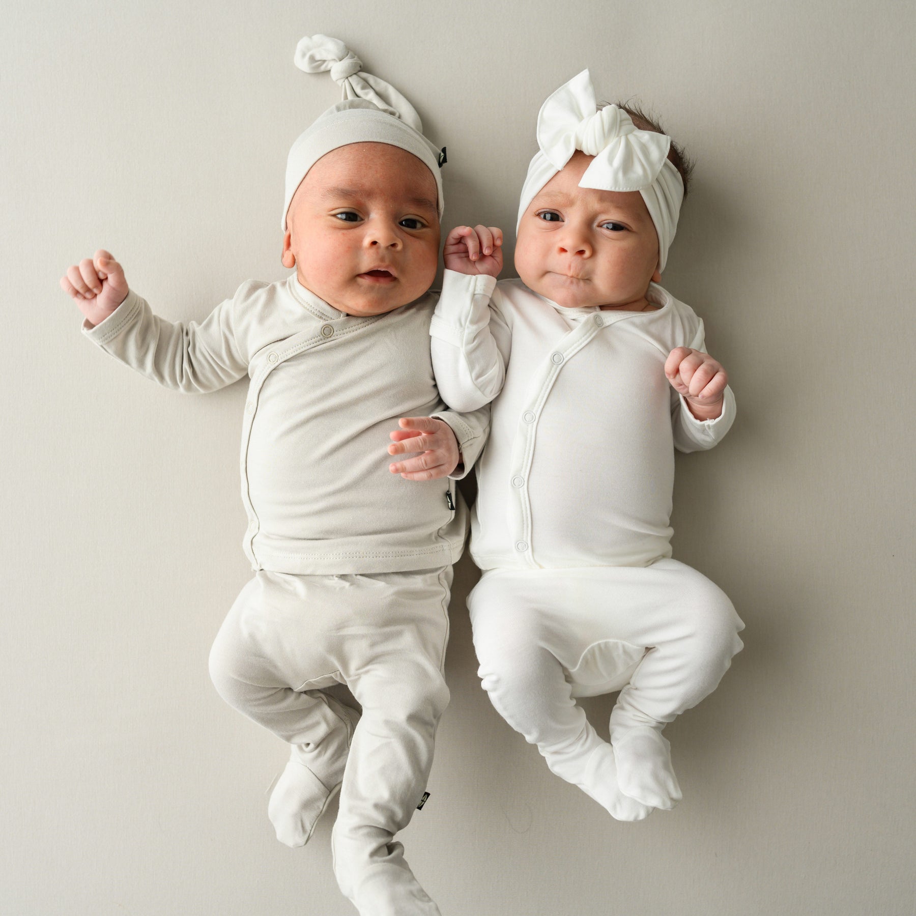 Babies in Take Me Home Set with Cap in Oat and Take Me Home Set with Bow in Cloud