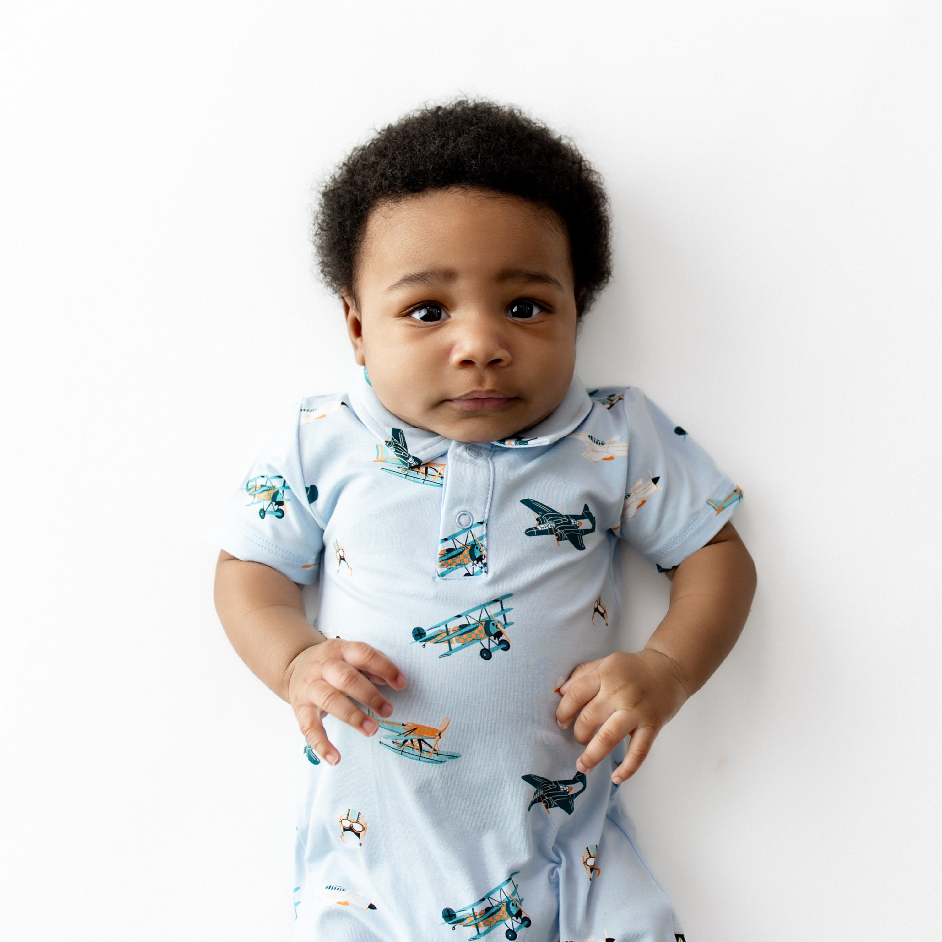 Close up of infant wearing the Polo Shortall in Take Off