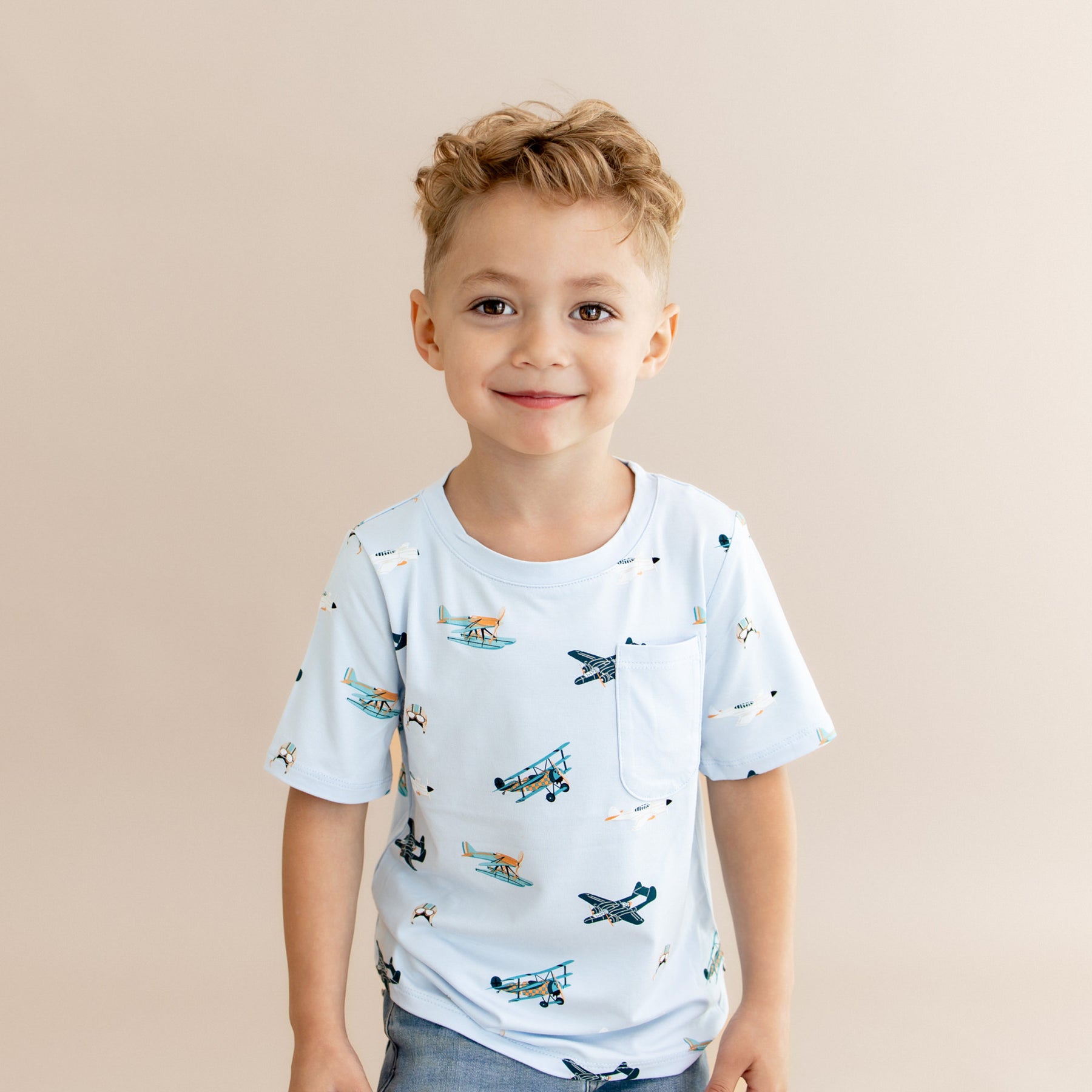 Smiling boy wearing the Toddler Crew Neck Tee in Take Off