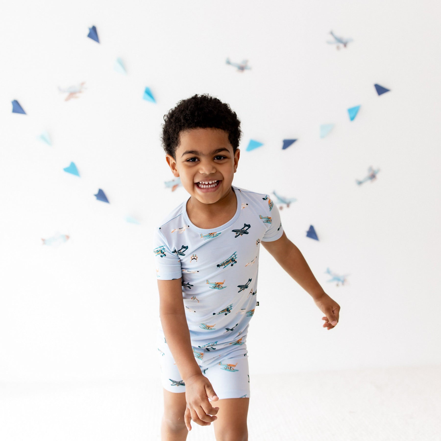 Smiling boy walking wearing the Short Sleeve Pajamas in Take Off