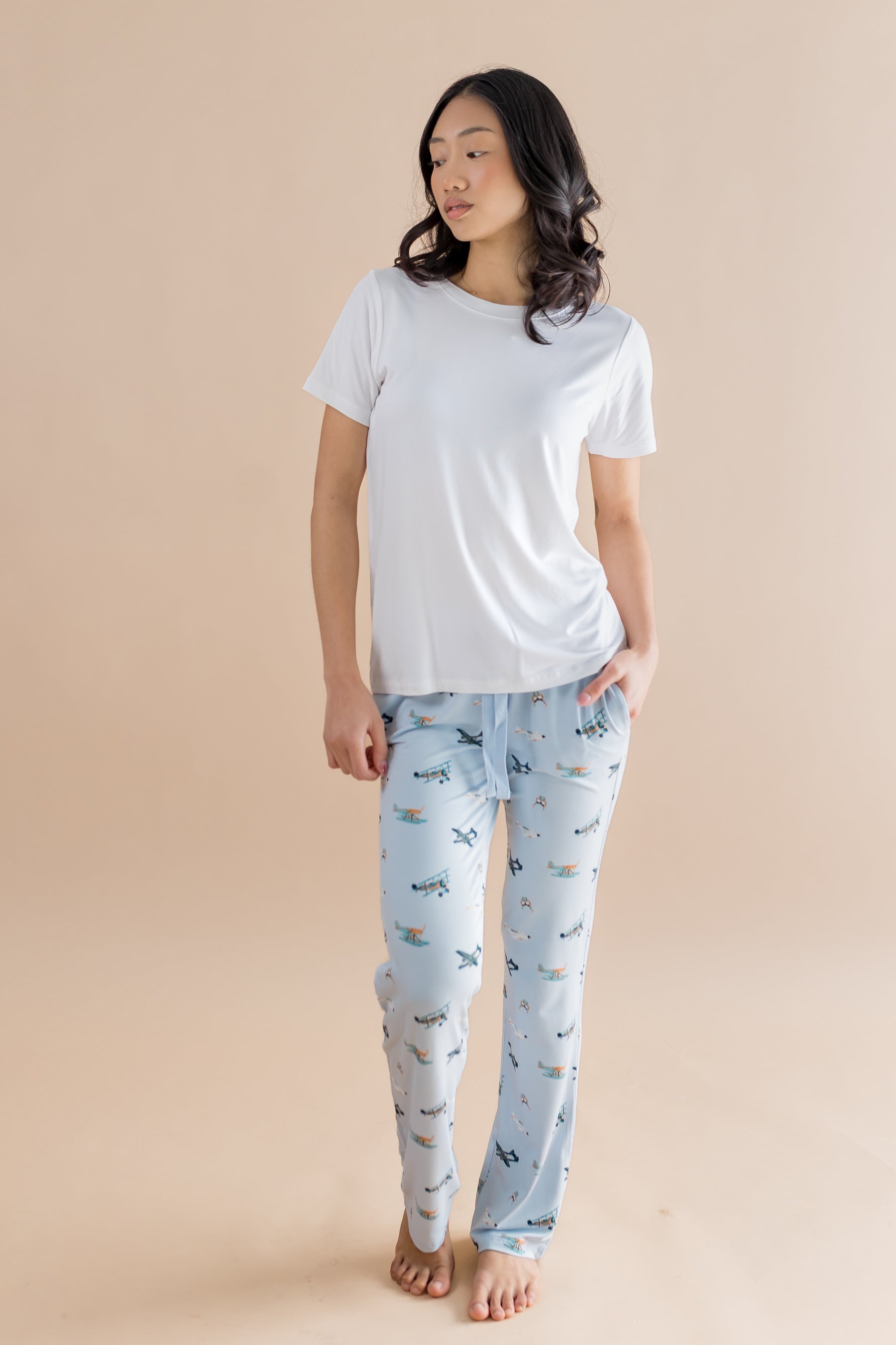 Female model posing wearing the Women's Lounge Pants in Take Off paired with a white shirt