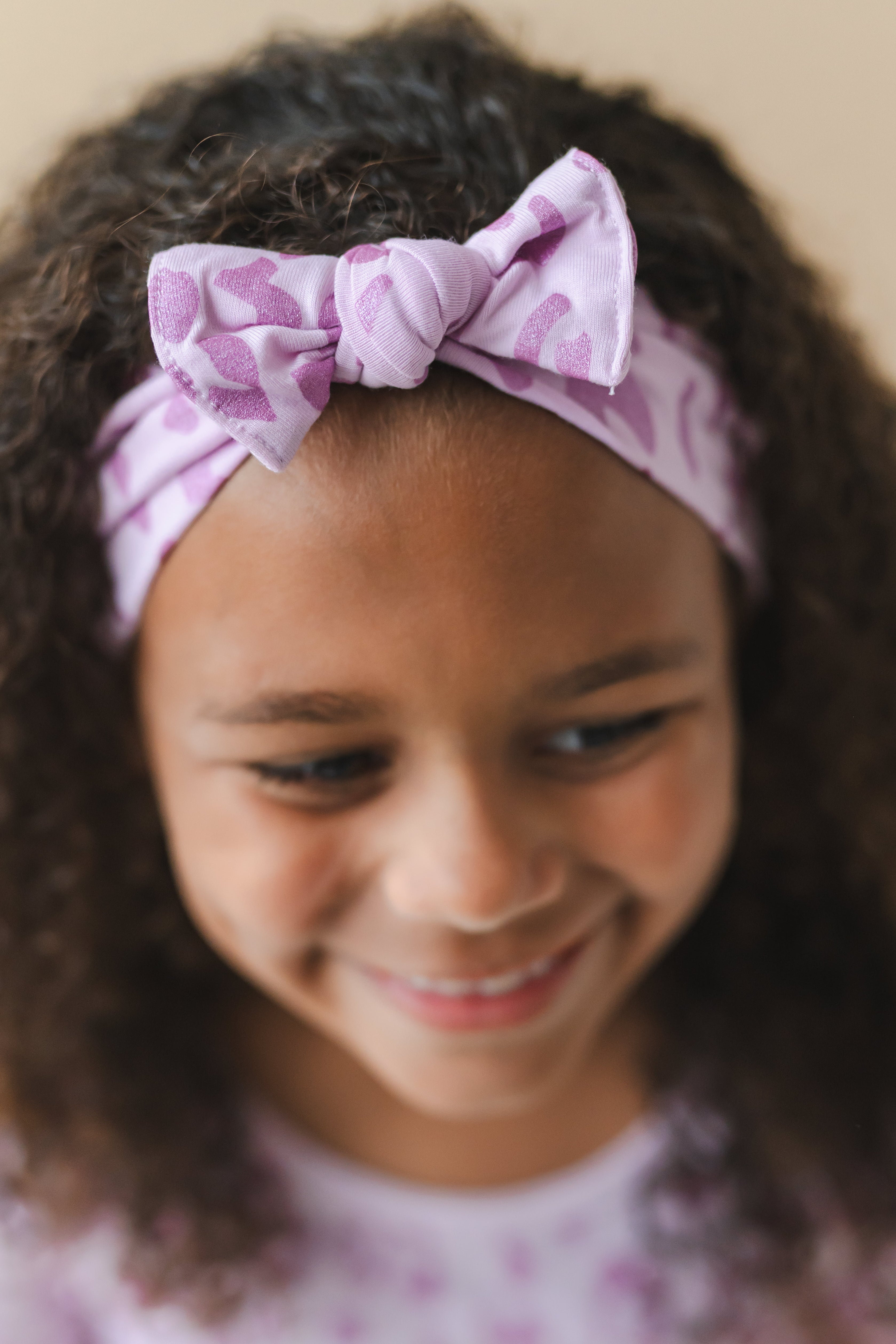 Child wearing a Thistle Leopard print Knotted Bow headband